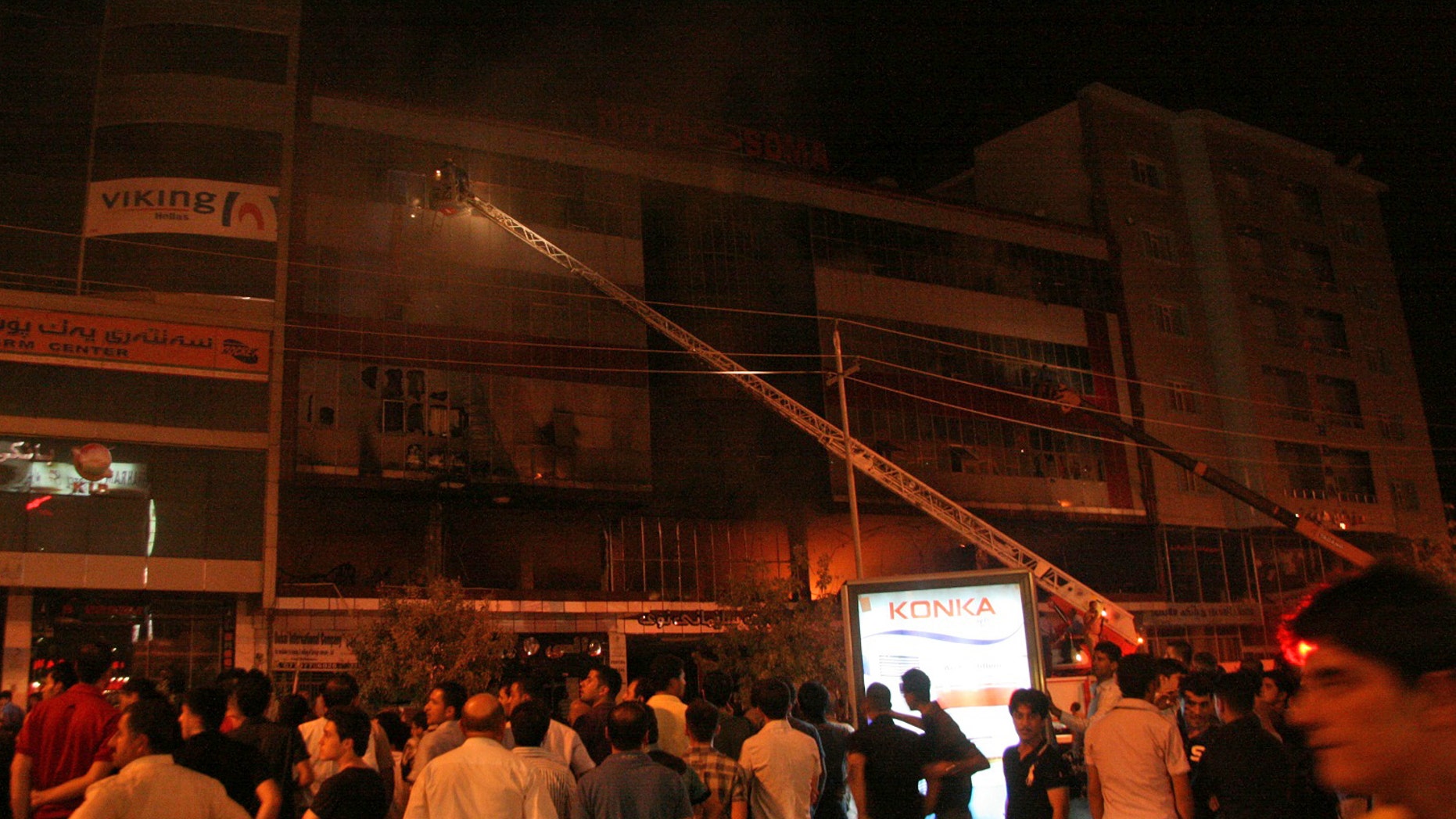 July 16: Iraqis gather as firefighters respond to a fire in a five-story hotel in Sulaimaniyah, 160 miles northeast of Baghdad. Some of the victims appeared to have died as they jumped from the windows to escape the blaze.