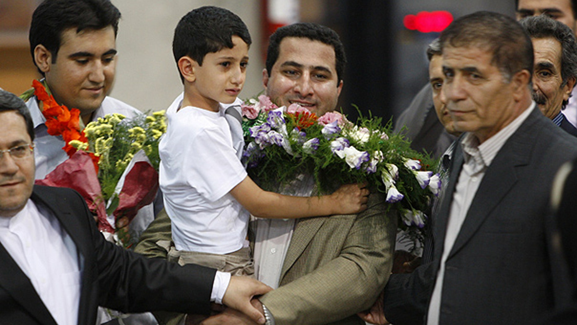 July 15: Shahram Amiri holds his 7-year-old son as he returns to a hero's welcome near Tehran, Iran.