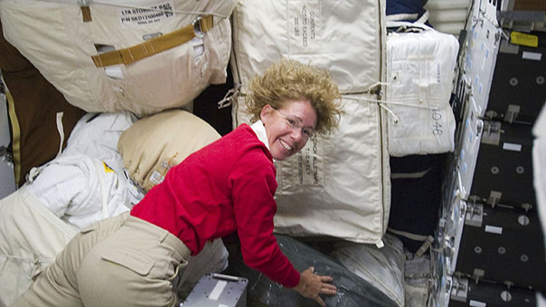 July 10: Photo provided by NASA, NASA astronaut Sandy Magnus, STS-135 mission specialist, is pictured with only a small portion of supplies and equipment on the middeck of the space shuttle Atlantis.
