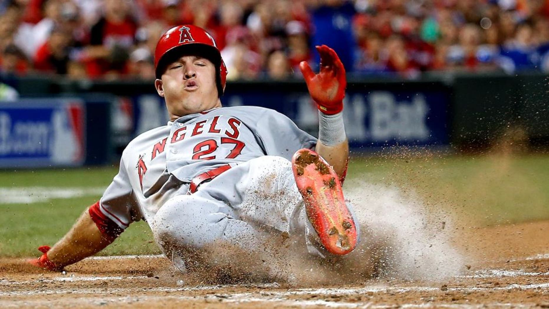 CINCINNATI, OH - JULY 14: American League All-Star Mike Trout #27 of the Los Angeles Angels of Anaheim slides home to score off of American League All-Star Prince Fielder #84 of the Texas Rangers single to left field against National League All-Star Clayton Kershaw #22 of the Los Angeles Dodgers during the 86th MLB All-Star Game at the Great American Ball Park on July 14, 2015 in Cincinnati, Ohio. (Photo by Rob Carr/Getty Images)