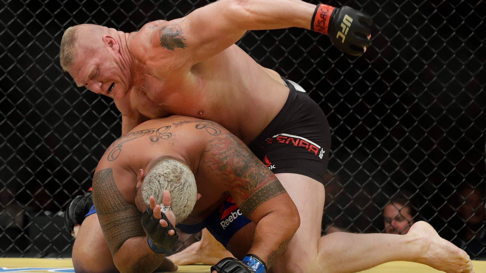 Brock Lesnar, top, fights Mark Hunt during their heavyweight mixed martial arts bout at UFC 200, Saturday, July 9, 2016, in Las Vegas.