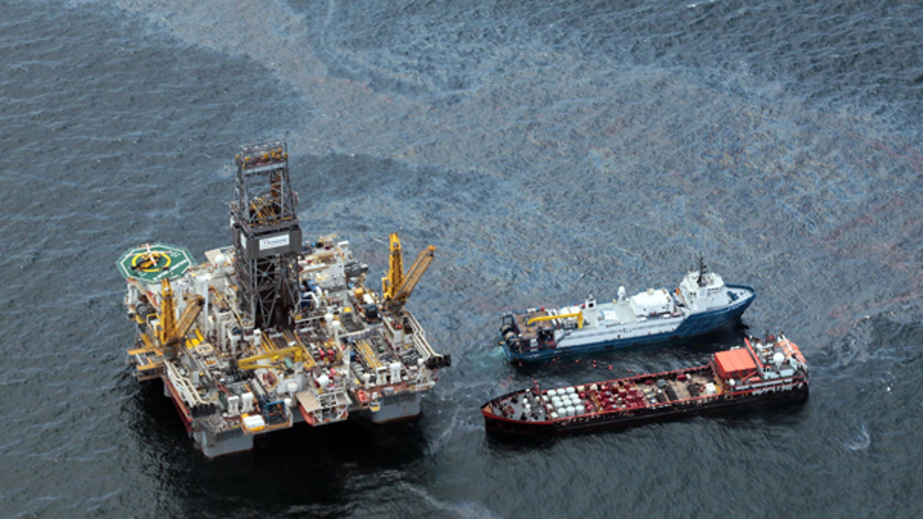 July 16: Workboats operate near BP's Transocean Development Drilling Rig II at the site of the Deepwater Horizon explosion in the Gulf of Mexico.