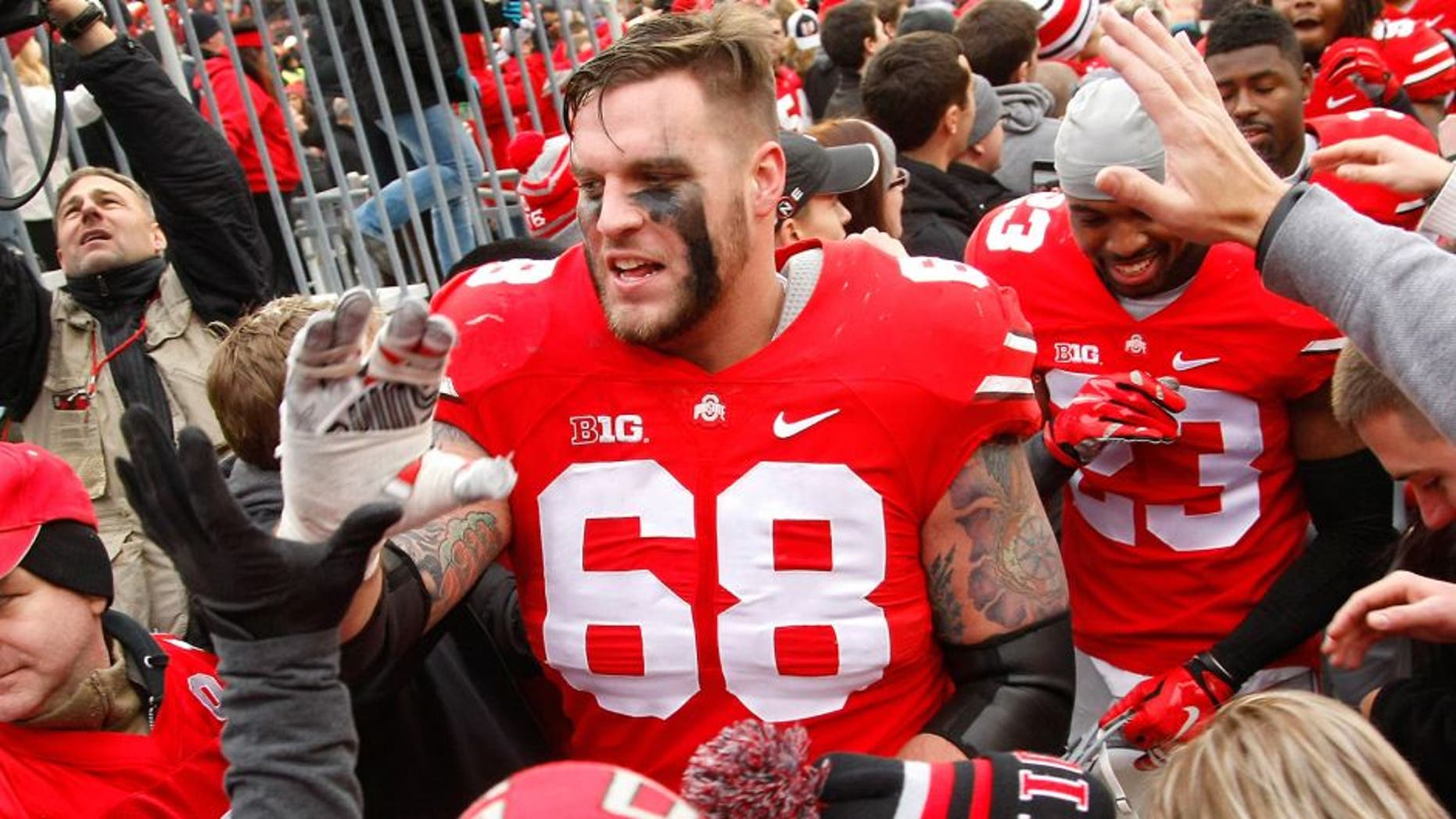 Nov 29, 2014; Columbus, OH, USA; Ohio State Buckeyes offensive lineman Taylor Decker (68) celebrates with fans following the game versus the Michigan Wolverines at Ohio Stadium. Ohio State won the game 42-28. Mandatory Credit: Joe Maiorana-USA TODAY Sports