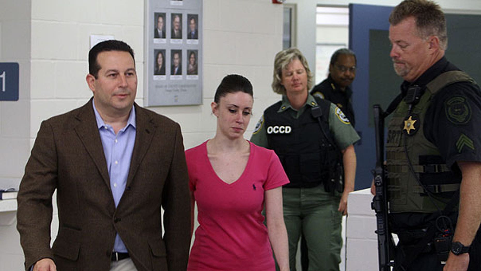 July 17: Casey Anthony, center, walks out of the Orange County Jail with her attorney Jose Baez, left, during her release in Orlando, Fla., early Sunday.
