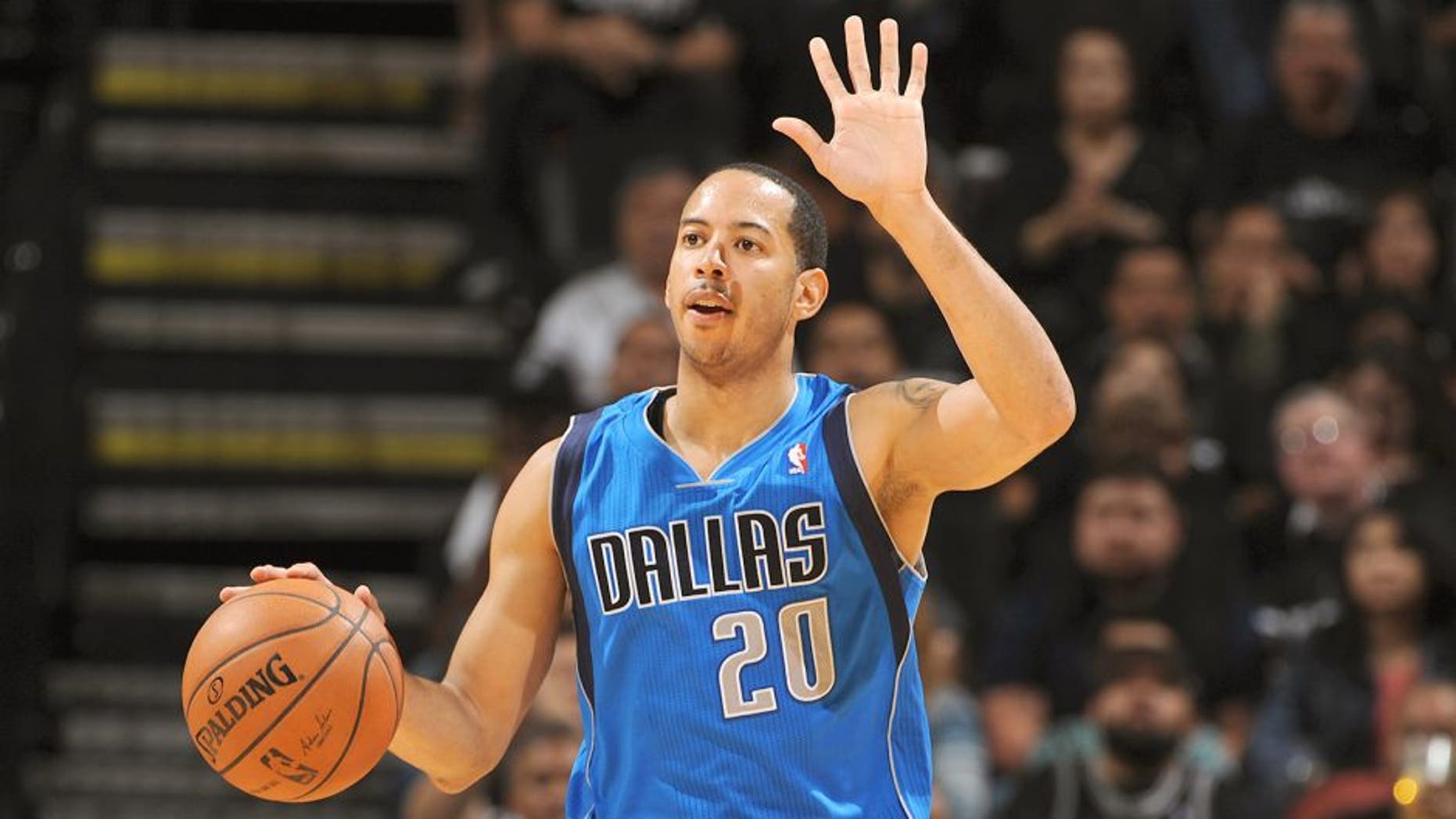 SAN ANTONIO, TX - APRIL 20: Devin Harris #20 of the Dallas Mavericks dribbles the ball during Game One of the Western Conference Quarterfinals during the 2014 NBA Playoffs against the San Antonio Spurs on April 20, 2014 at the AT&T Center in San Antonio, Texas. NOTE TO USER: User expressly acknowledges and agrees that, by downloading and/or using this Photograph, user is consenting to the terms and conditions of the Getty Images License Agreement. Mandatory Copyright Notice: Copyright 2013 NBAE (Photo by Garrett W. Ellwood/NBAE via Getty Images)