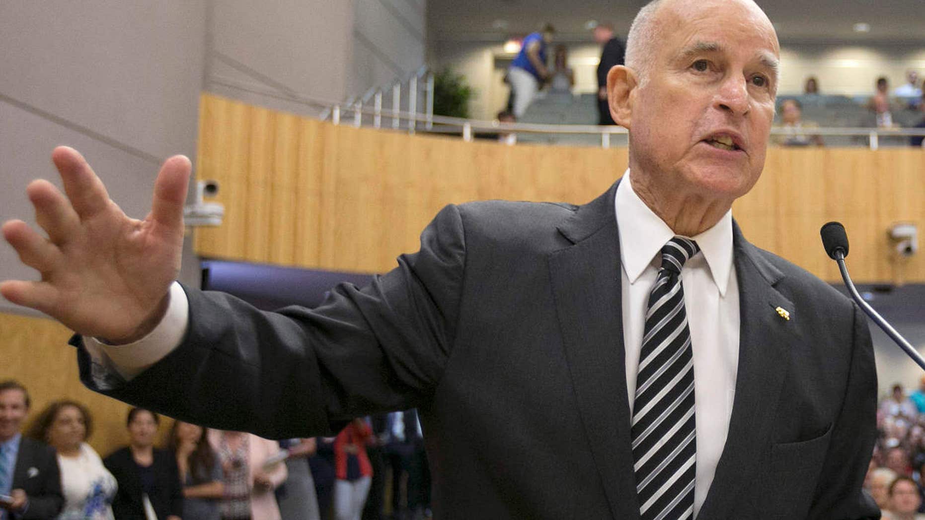 FILE - In this July 13, 2017 file photo, Calif., Gov. Jerry Brown, left, testifies in support of a pair of climate change bills as Senate President Pro Tem Kevin de Leon, D-Los Angeles, looks on during a hearing of the Senate Environmental Quality Committee, in Sacramento, Calif.