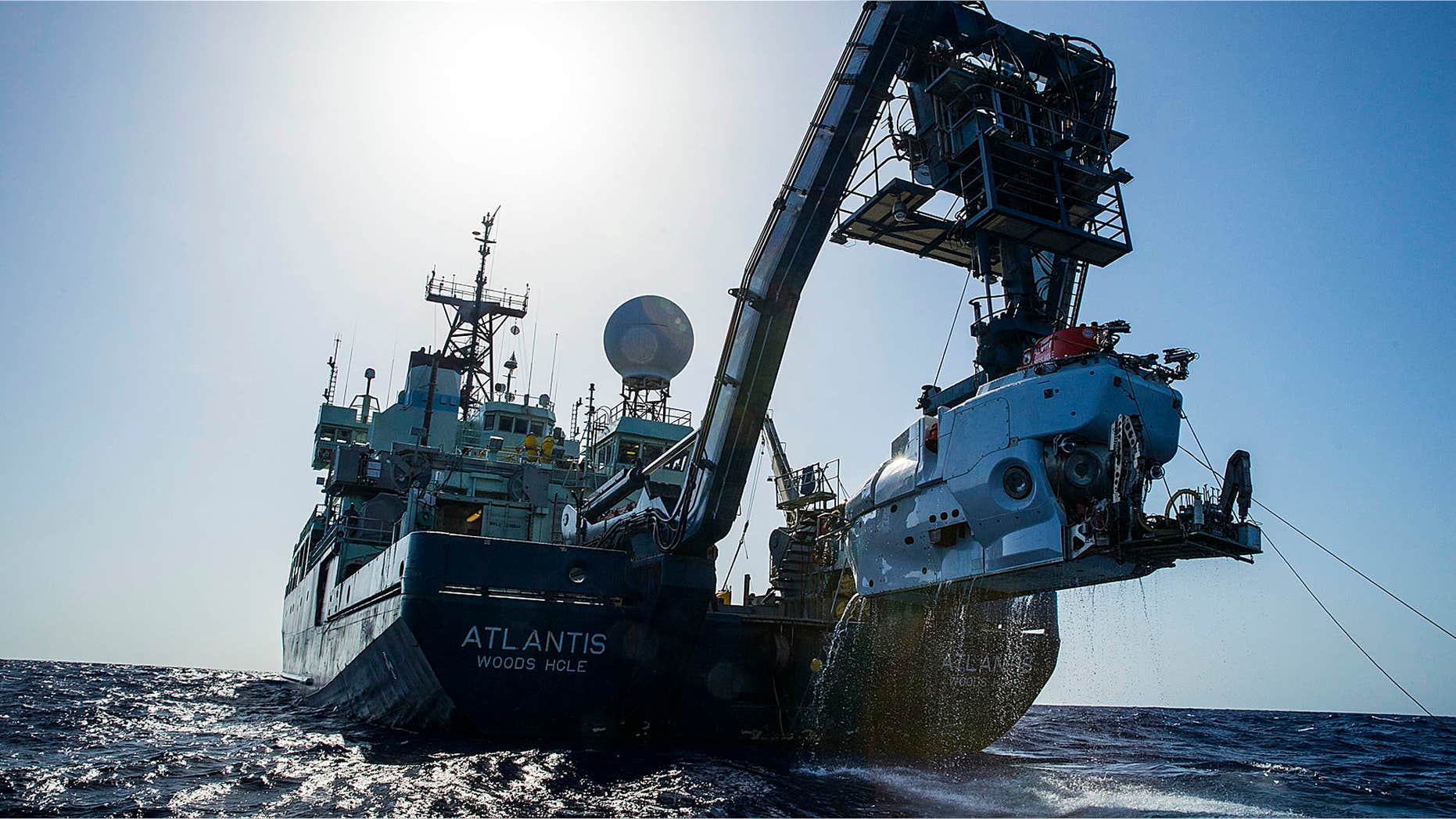 In this image released by, The Woods Hole Oceanographic Institution, the research vessel Atlantis is shown off the coast of the Carolinas in the Atlantic Ocean during the second week of July 2015 with the submersible Alvin hanging off its stern.