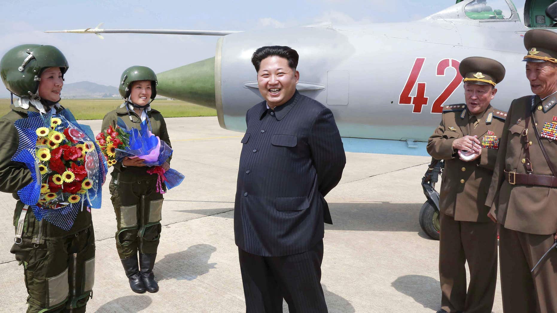June 22, 2016: North Korean leader Kim Jong Un smiles as he attends a flight training session by female fighter pilots Jo Kum Hyang and Rim Sol in this undated photo released by North Korea's Korean Central News Agency.