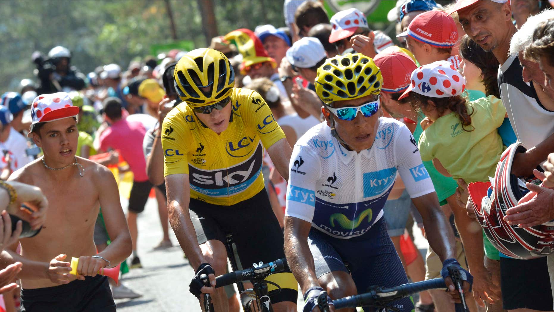 July 18, 2015: Colombia's Nairo Quintana, wearing the best young rider's white jersey, and Britain's Chris Froome, wearing the overall leader's yellow jersey, climb in the final kilometers of the fourteenth stage of the Tour de France cycling race over 178.5 kilometers (110.9 miles) with start in Rodez and finish in Mende, France.