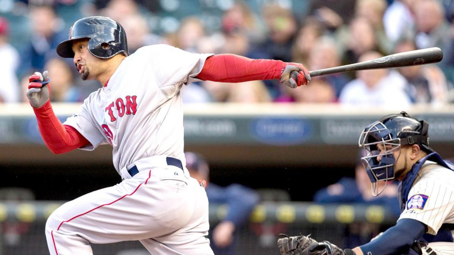 May 14, 2014; Minneapolis, MN, USA; Boston Red Sox right fielder Shane Victorino (18) hits a single in the first inning against the Minnesota Twins at Target Field. Mandatory Credit: Jesse Johnson-USA TODAY Sports