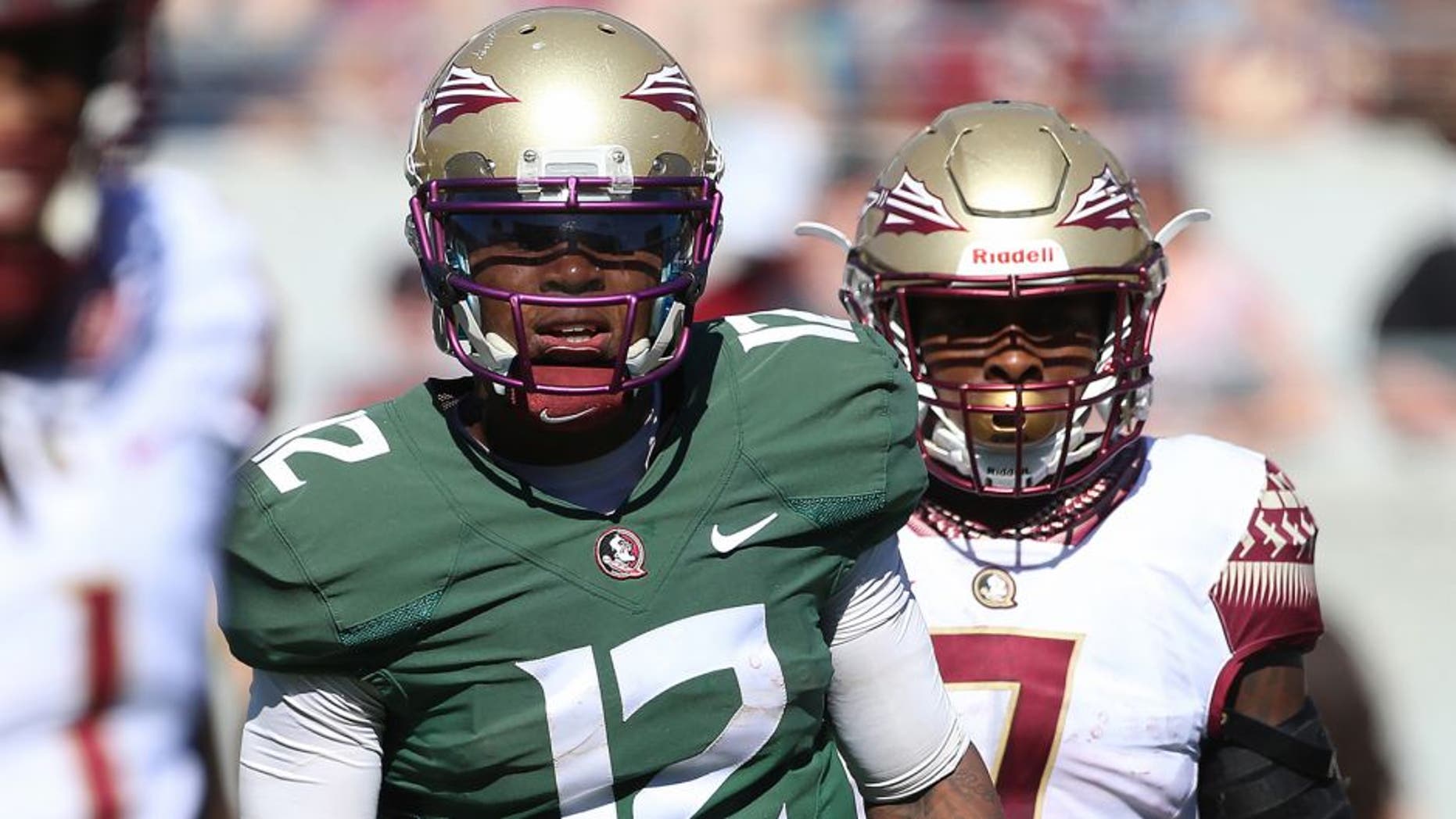 Apr 9, 2016; Orlando, FL, USA; Florida State Seminoles quarterback Deondre Francois (12) and running back Mario Pender (7) look to the sideline during the Florida State spring game at the Citrus Bowl. Mandatory Credit: Logan Bowles-USA TODAY Sports