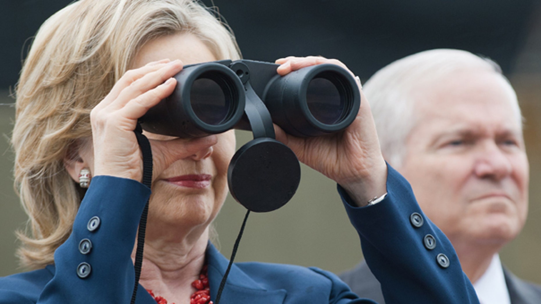 July 21: U.S. Secretary of State Hillary Clinton looks towards North Korea as U.S. Secretary of Defense Robert Gates stands nearby in Camp Oulette in the demilitarized zone that separates the two Koreas.