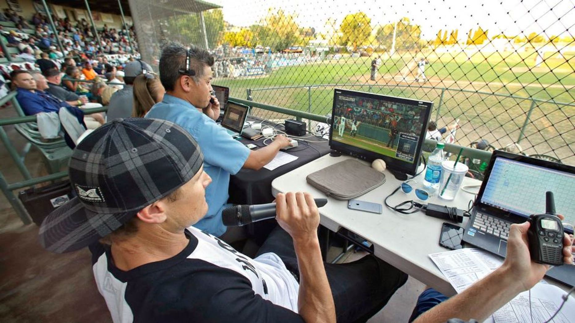 Former major league outfielder Eric Byrnes uses a computerized video system to call balls and strikes at an independent minor league baseball game between the San Rafael Pacifics and Vallejo Admirals Tuesday, July 28, 2015, in San Rafael, Calif. On Tuesday night, the computer system stood in for pitch calls in what is considered to be the first professional game without the umpire making those decisions. A full umpiring crew will be there for everything else. (AP Photo/Eric Risberg)