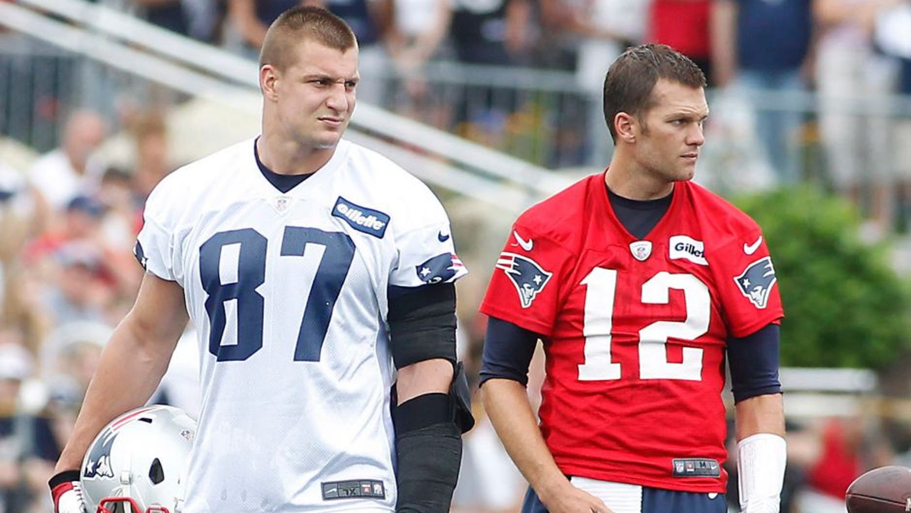 Jul 24, 2014; Foxborough, MA, USA; New England Patriots tight end Rob Gronkowski (87) and quarterback Tom Brady (12) during training camp at the team practice facility. Mandatory Credit: Stew Milne-USA TODAY Sports
