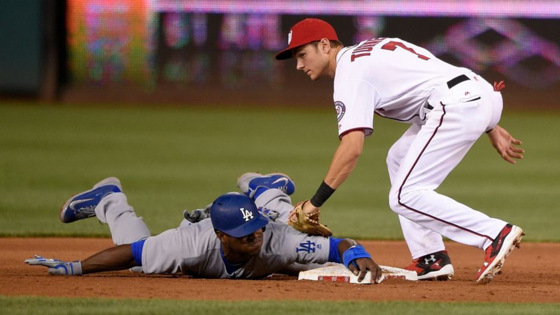 Los Angeles Dodgers' Yasiel Puig, bottom, is safe as he stole second against Washington Nationals second baseman Trea Turner (7) during the fifth inning of a baseball game, Tuesday, July 19, 2016, in Washington. The Dodgers won 8-4. (AP Photo/Nick Wass)