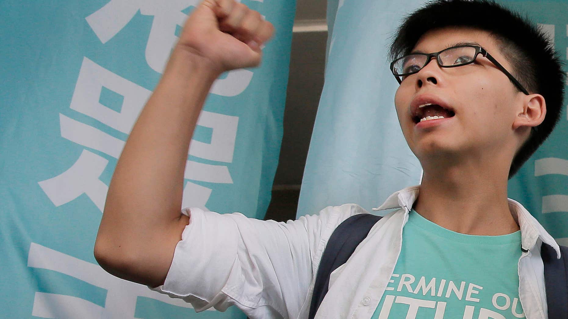 July 21, 2016: Teen protest leader Joshua Wong shouts slogans outside a magistrate's court in Hong Kong.