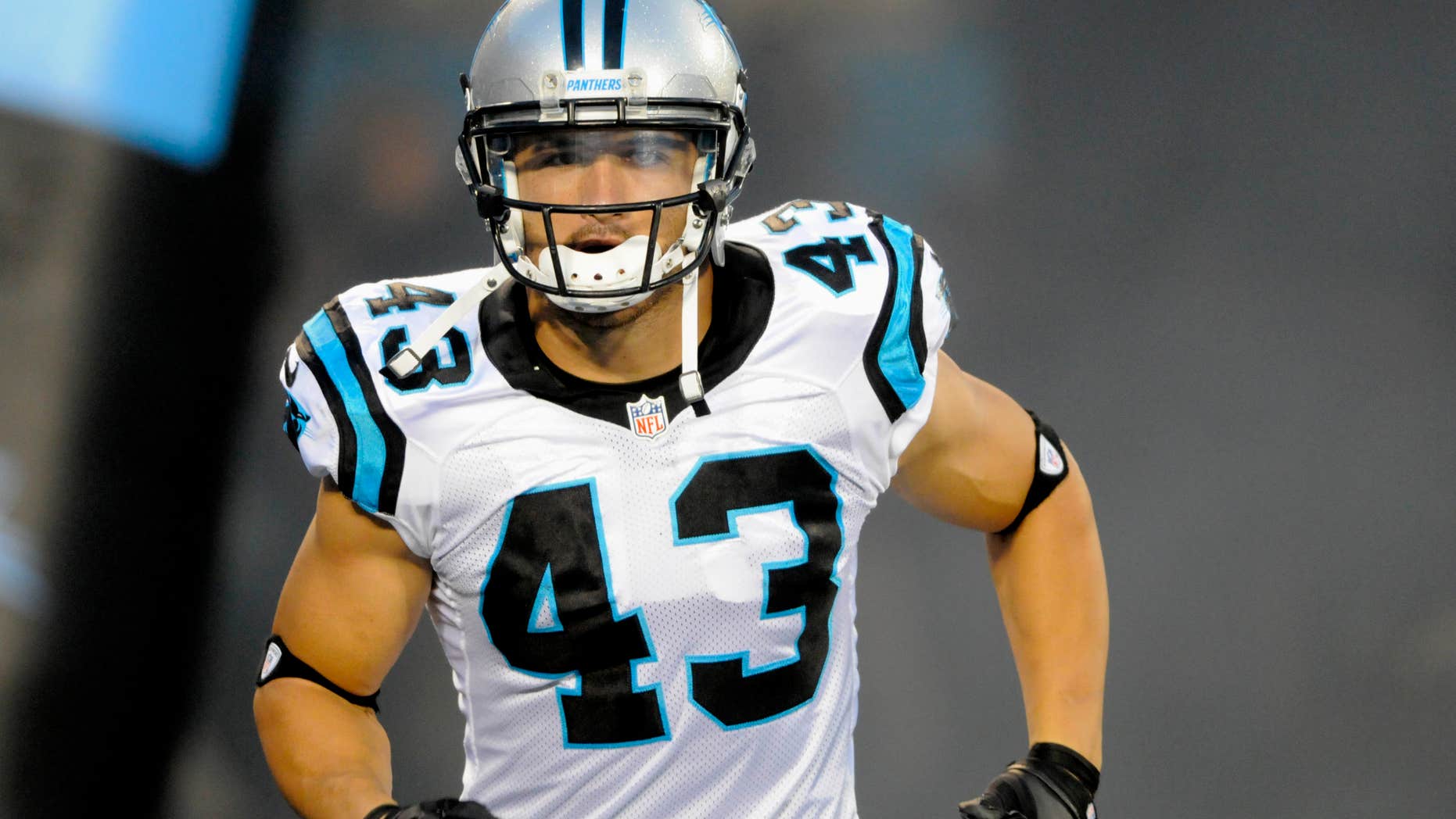 FILE - In this Aug. 17, 2012, file photo, Carolina Panthers' Haruki Nakamura (43) runs onto the field during player introductions before an NFL football game against the Miami Dolphins in Charlotte, N.C.