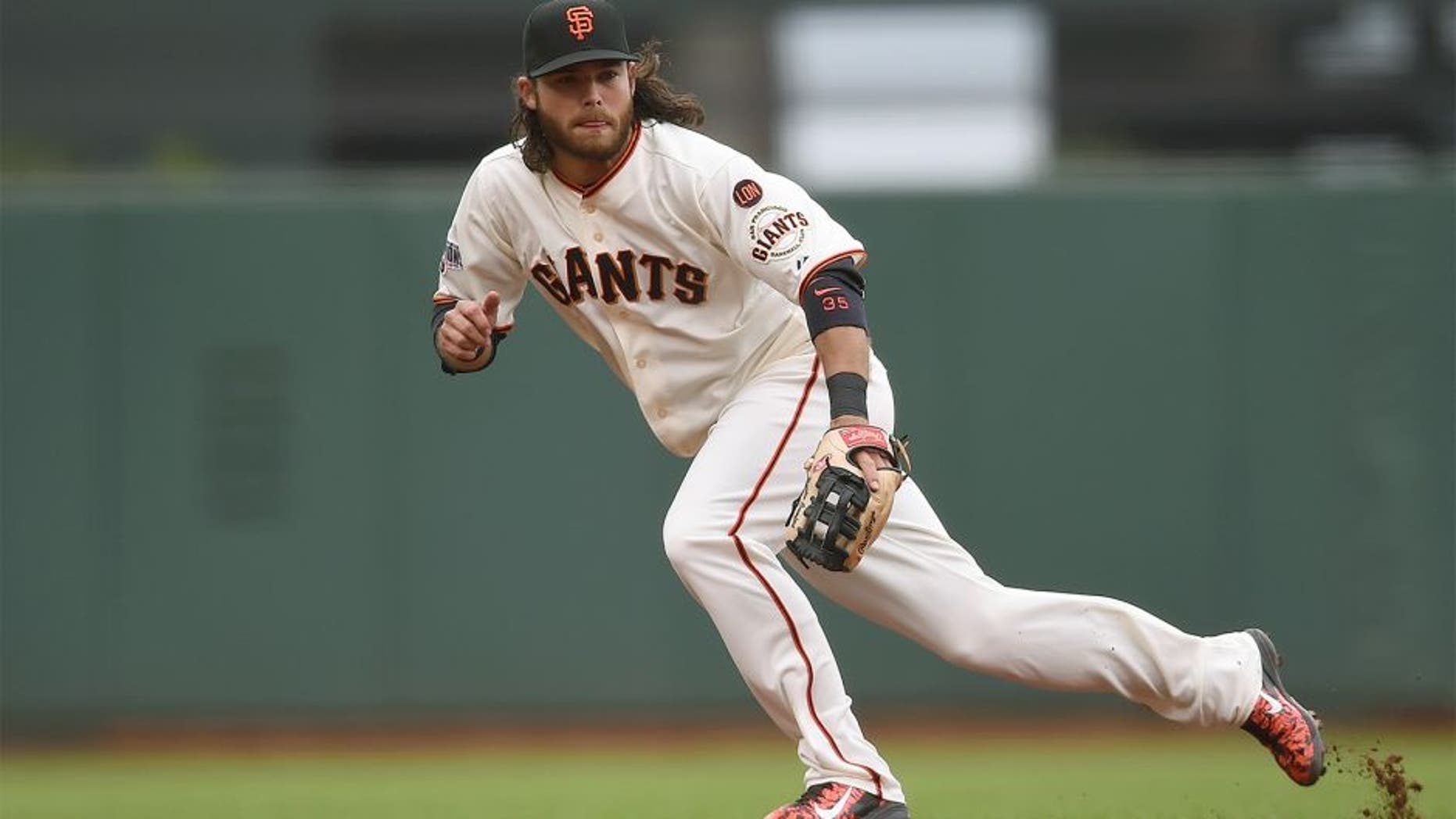 SAN FRANCISCO, CA - JULY 08: Brandon Crawford #35 of the San Francisco Giants reacts to his right of a ball that goes for a basehit off the bat of Wilmer Flores #4 of the New York Mets in the top of the fourth inning at AT&T Park on July 8, 2015 in San Francisco, California. (Photo by Thearon W. Henderson/Getty Images)