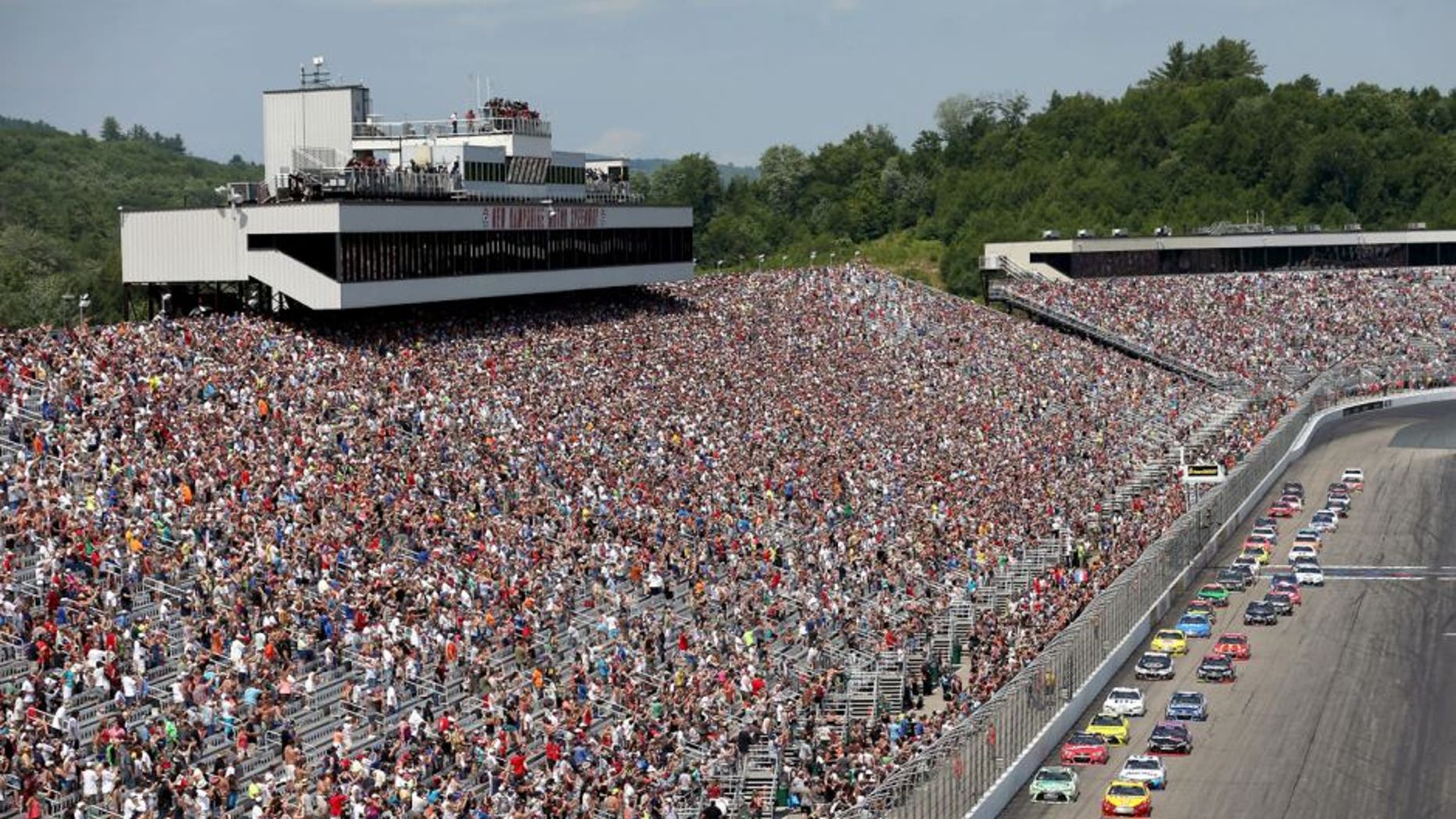 LOUDON, NH - JULY 19: Carl Edwards, driver of the #19 Sport Clips Toyota, leads the field to turn one after taking the green flag to start the NASCAR Sprint Cup Series 5-Hour ENERGY 301 at New Hampshire Motor Speedway on July 19, 2015 in Loudon, New Hampshire. (Photo by Nick Laham/Getty Images)