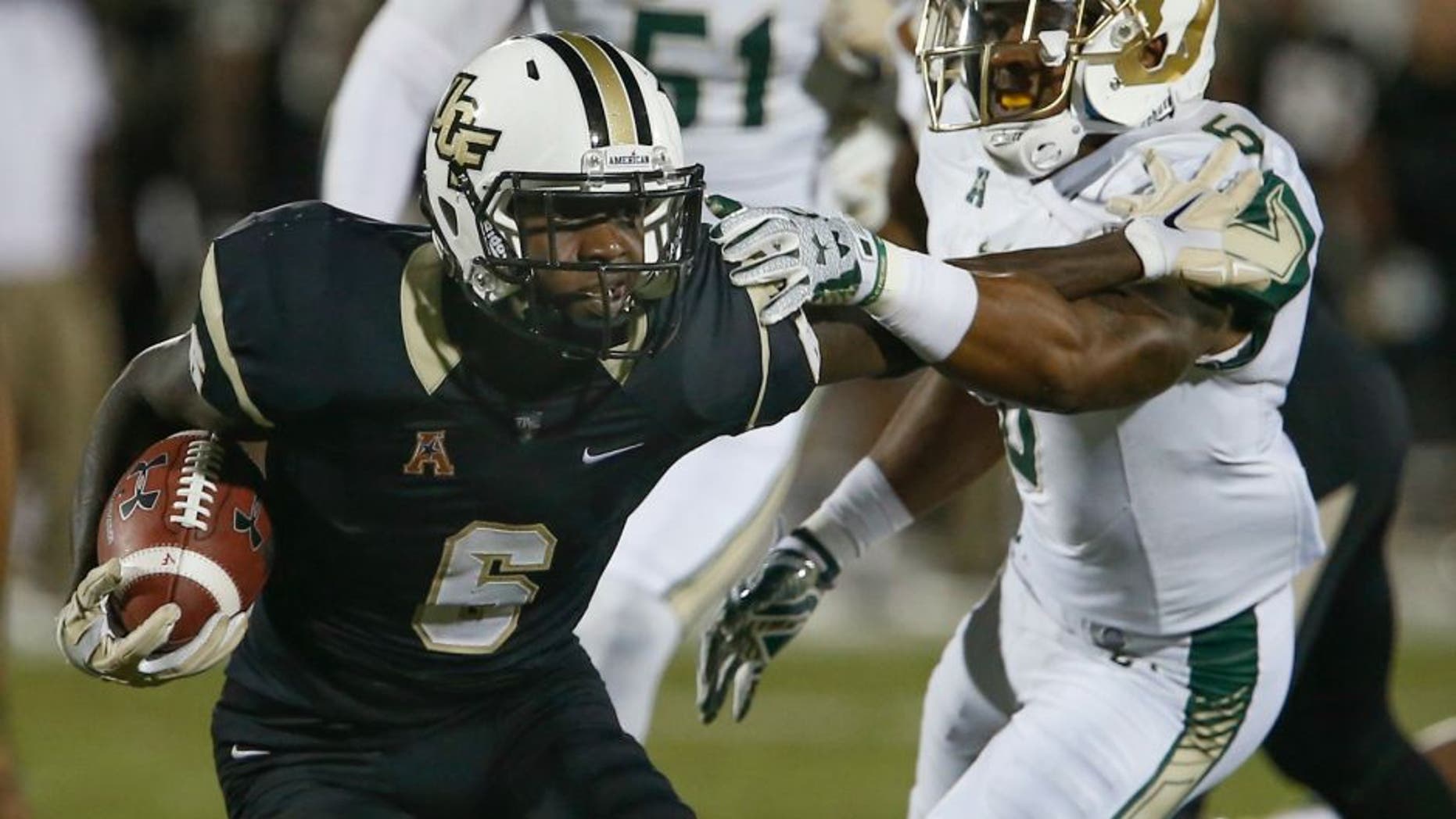 Nov 26, 2015; Orlando, FL, USA; South Florida Bulls defensive back Lamar Robbins (6) grabs Central Florida Knights wide receiver Tristan Payton (6) during the second half of a football game at Bright House Networks Stadium. South Florida Bulls won 44-3. Mandatory Credit: Reinhold Matay-USA TODAY Sports