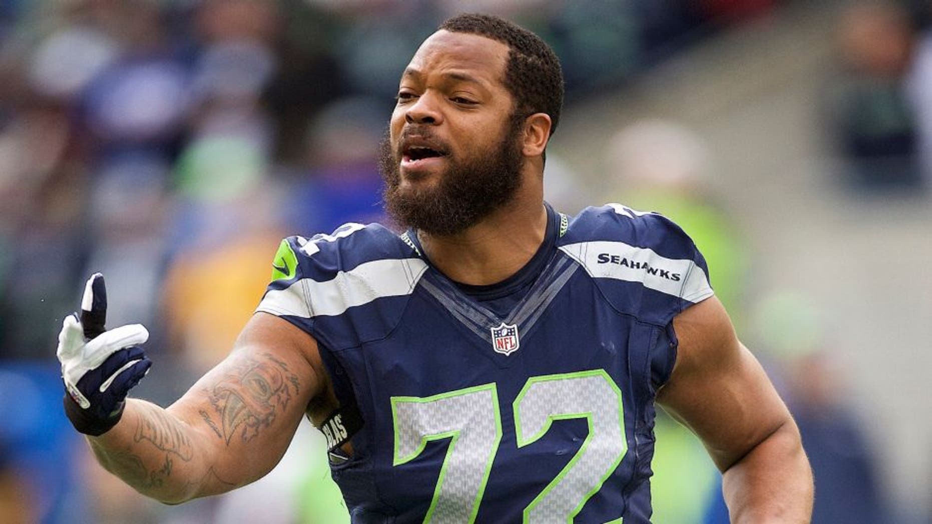 Dec 20, 2015; Seattle, WA, USA; Seattle Seahawks defensive end Michael Bennett (72) takes a break during a game against the Cleveland Browns at CenturyLink Field. The Seahawks won 30-13. Mandatory Credit: Troy Wayrynen-USA TODAY Sports