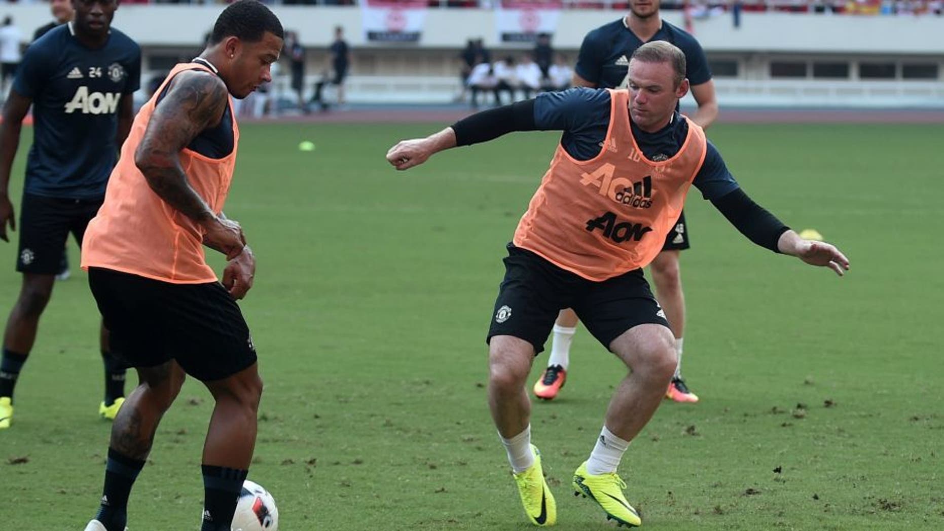 SHANGHAI, CHINA - JULY 21: Wayne Rooney (R) of Manchester United attends first team training session as part of their pre-season tour of China during the 2016 International Champions Cup football match between Manchester United and Dortmund on July 21, 2016 in Shanghai, China. (Photo by VCG)***_***