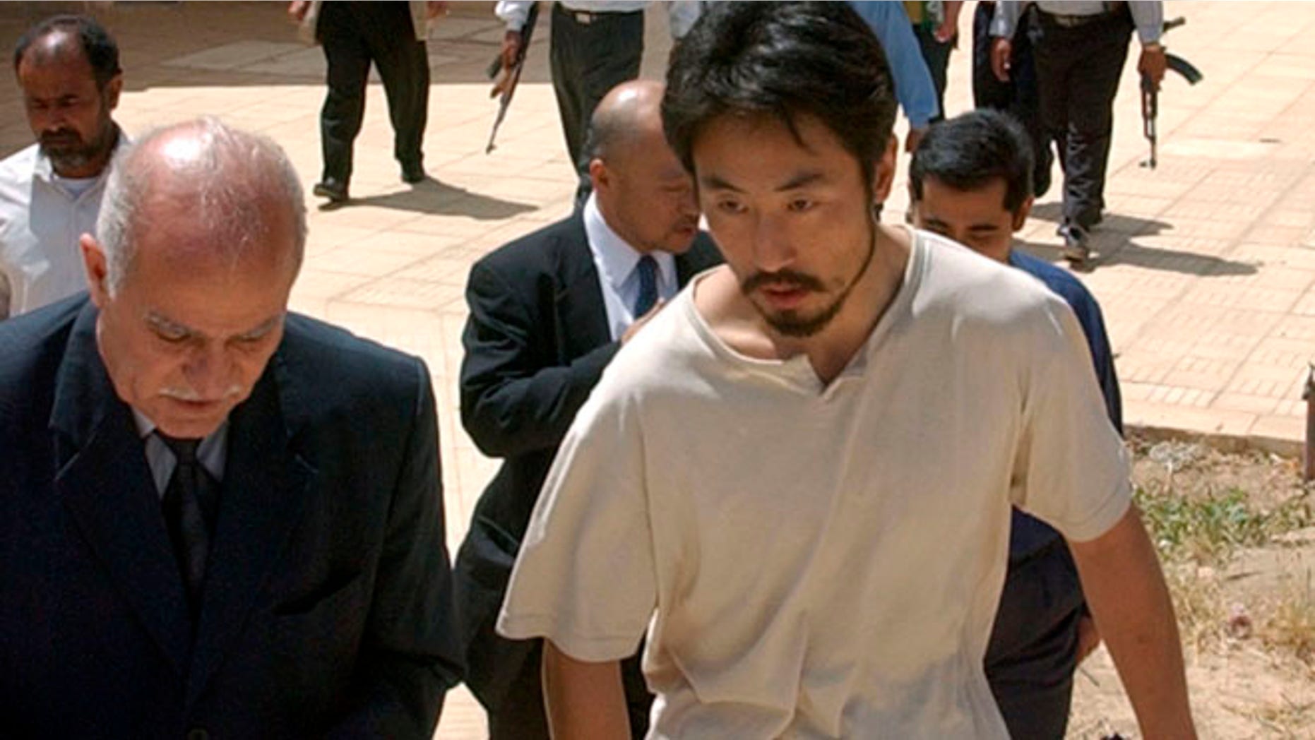 April 17, 2004: Japanese freelance journalist Jumpei Yasuda, right, is escorted after being released at Umm Al-Qura mosque in Baghdad, Iraq. Worries are growing about the whereabouts of the freelance Japanese journalist, last heard from late June, 2015, in Syria.