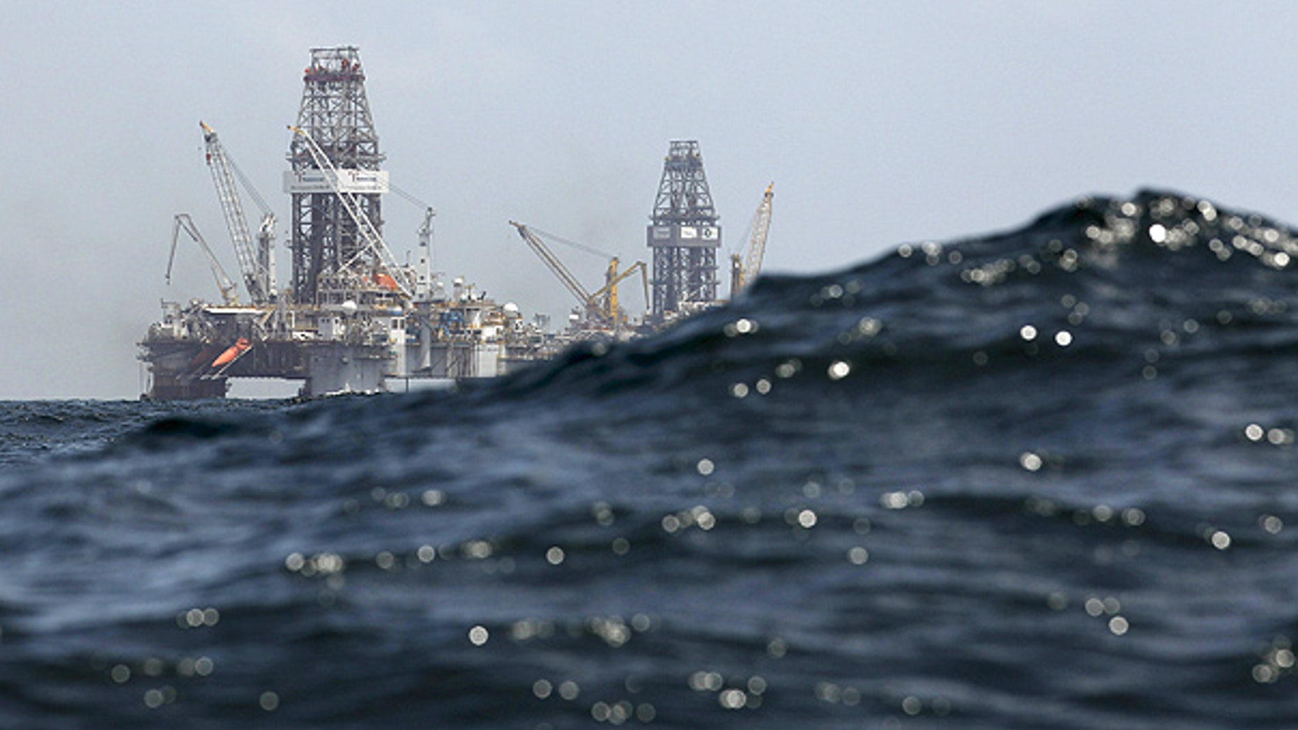July 22: Waves partially obscure rigs drilling the relief wells at the Deepwater Horizon oil spill site in the Gulf of Mexico.
