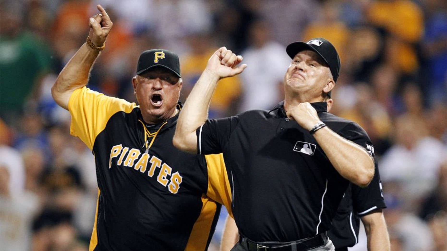 Jul 22, 2014; Pittsburgh, PA, USA; Pittsburgh Pirates manager Clint Hurdle (13) is ejected by third base umpire Jeff Nelson (45) against the Los Angeles Dodgers during the seventh inning at PNC Park. Mandatory Credit: Charles LeClaire-USA TODAY Sports