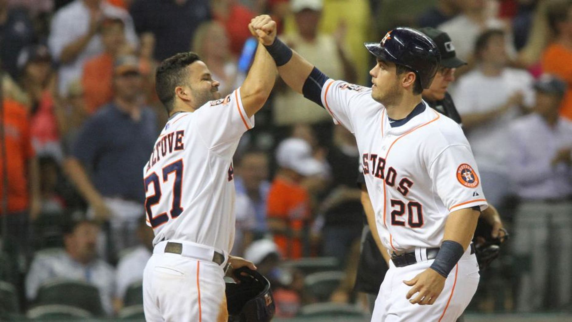 Houston Astros' Preston Tucker is greeted at the plate by Jose Altuve, left, after his two-run home run against the Boston Red Sox during the fifth inning of a baseball game Wednesday, July 22, 2015, in Houston. (AP Photo/Richard Carson)