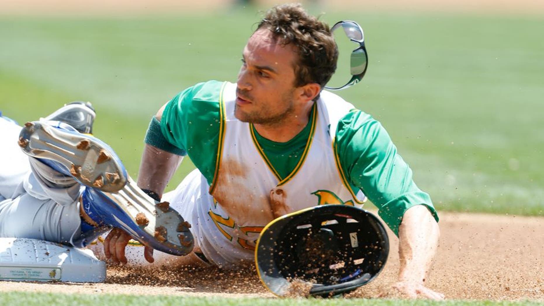 OAKLAND, CA - JUNE 27: Sam Fuld #23 of the Oakland Athletics slides safely into third, on a triple, during the game against the Kansas City Royals at O.co Coliseum on June 27, 2015 in Oakland, California. The Royals defeated the Athletics 3-2. (Photo by Michael Zagaris/Oakland Athletics/Getty Images)