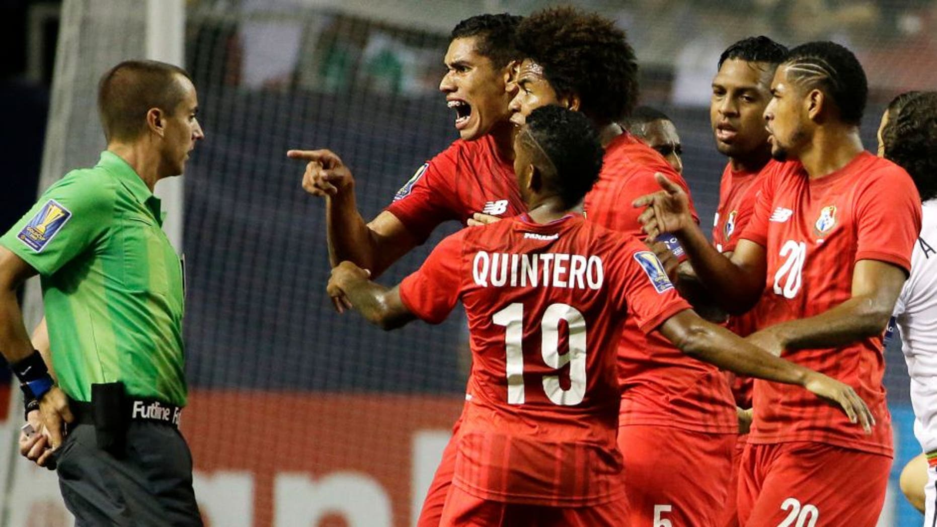 Panama's Valentin Pimentel, center right, points at referee Mark Geiger, who had given a red card to Panama's Luis Tejada, not seen, during the first half of Panama's CONCACAF Gold Cup soccer semifinal against Mexico on Wednesday, July 22, 2015, in Atlanta. (AP Photo/David Goldman)