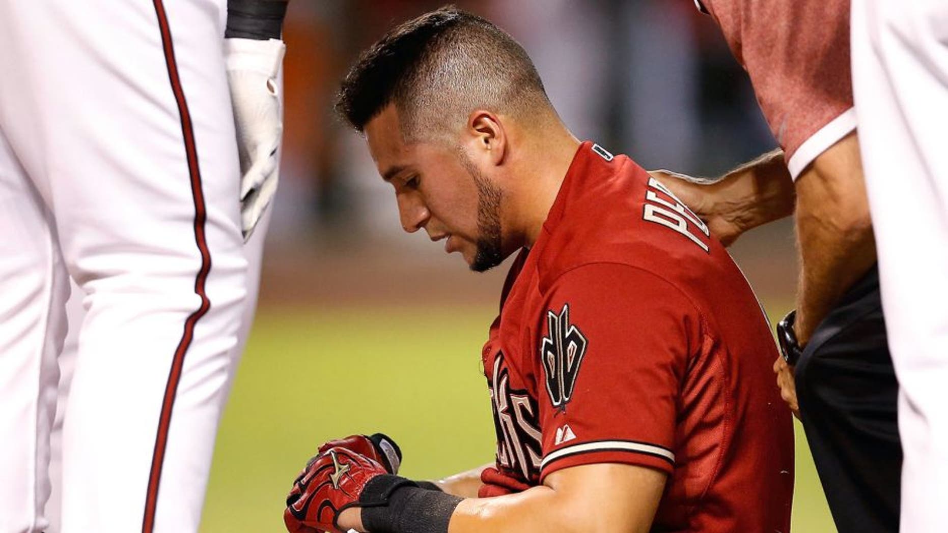 PHOENIX, AZ - JULY 22: David Peralta #6 of the Arizona Diamondbacks sits up after being hit in the head by a pitch from starting pitcher Jose Fernandez (not pictured) of the Miami Marlins during the sixth inning of the MLB game at Chase Field on July 22, 2015 in Phoenix, Arizona. (Photo by Christian Petersen/Getty Images)