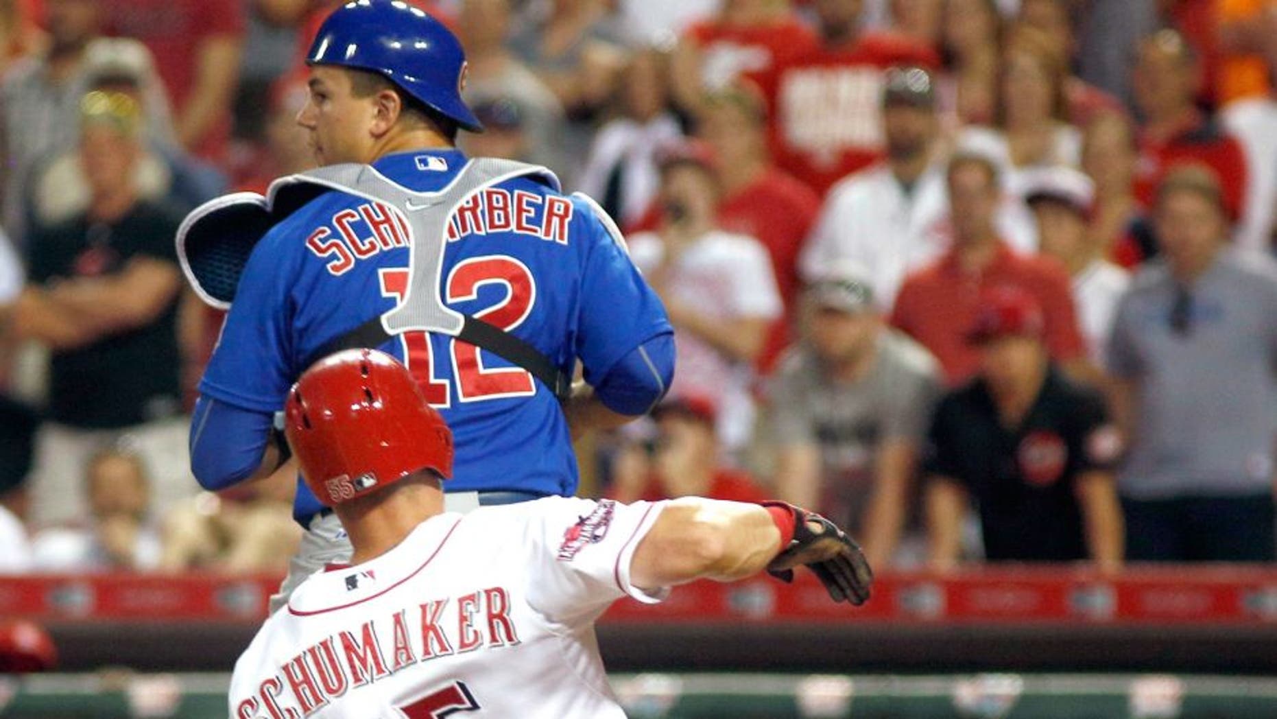 Jul 22, 2015; Cincinnati, OH, USA; Cincinnati Reds left fielder Skip Schumaker (55) is forced out a home under Chicago Cubs catcher Kyle Schwarber (12) in the eighth inning at Great American Ball Park. The Cubs won 6-5. Mandatory Credit: David Kohl-USA TODAY Sports