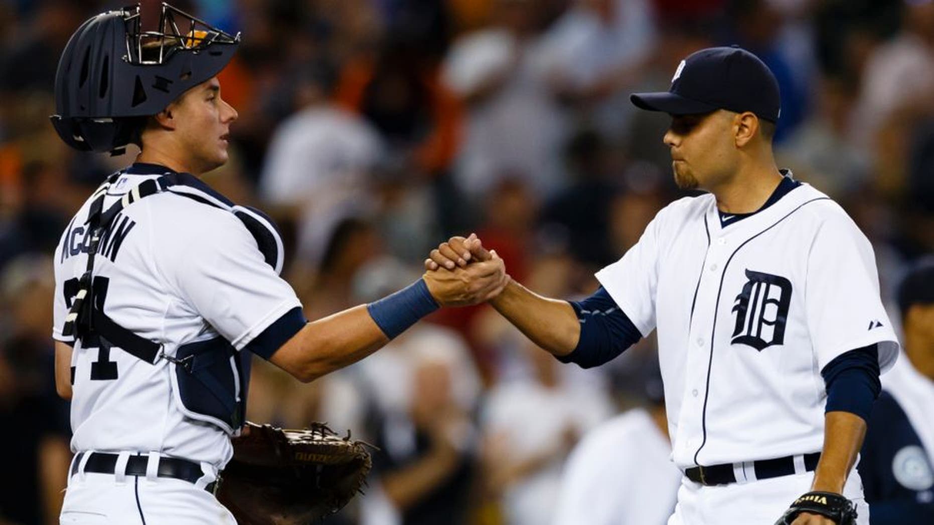 Jul 22, 2015; Detroit, MI, USA; Detroit Tigers first baseman Miguel Cabrera (24) and relief pitcher Joakim Soria (38) celebrate after their game against the Seattle Mariners at Comerica Park. The Tigers won 9-4. Mandatory Credit: Rick Osentoski-USA TODAY Sports