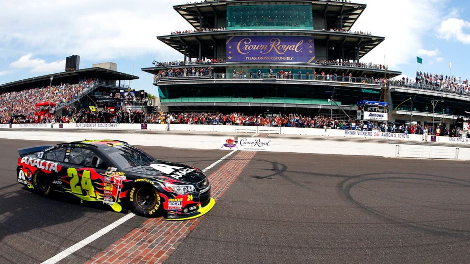INDIANAPOLIS, IN - JULY 27: Jeff Gordon, driver of the #24 Axalta Chevrolet, takes the checkered flag to win the NASCAR Sprint Cup Series Crown Royal Presents The John Wayne Walding 400 at the Brickyard Indianapolis Motor Speedway on July 27, 2014 in Indianapolis, Indiana. (Photo by Matt Sullivan/Getty Images)