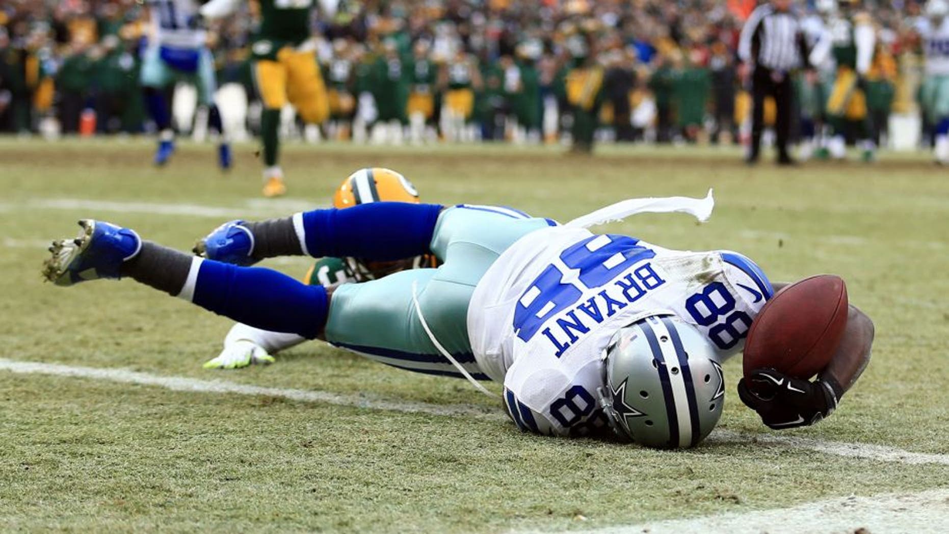 Jan 11, 2015; Green Bay, WI, USA; Dallas Cowboys wide receiver Dez Bryant (88) is unable to catch a pass against Green Bay Packers cornerback Sam Shields (37) in the fourth quarter in the 2014 NFC Divisional playoff football game at Lambeau Field. Mandatory Credit: Andrew Weber-USA TODAY Sports