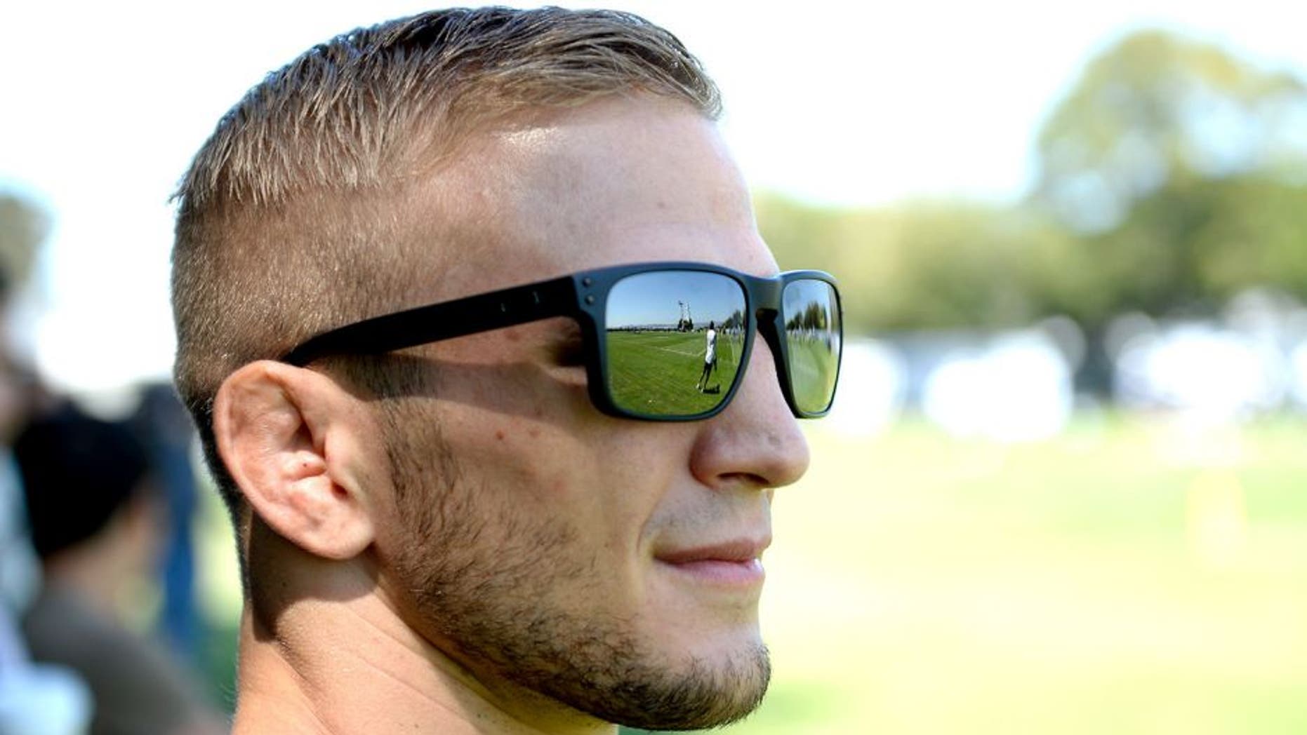 ALAMEDA, CA - AUGUST 26: UFC bantamweight champion TJ Dillashaw attends Oakland Raiders practice at the their training facility on August 26, 2014 in Alameda, California. (Photo by Jeff Bottari/Zuffa LLC/Zuffa LLC via Getty Images) *** Local Caption ***TJ Dillashaw