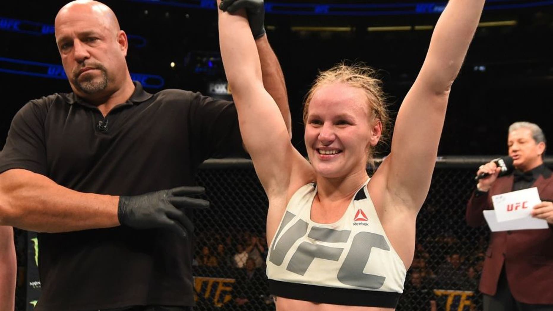 ORLANDO, FL - DECEMBER 19: (R-L) Valentina Shevchenko celebrates her victory over Sarah Kaufman in their women's bantamweight bout during the UFC Fight Night event at the Amway Center on December 19, 2015 in Orlando, Florida. (Photo by Josh Hedges/Zuffa LLC/Zuffa LLC via Getty Images)