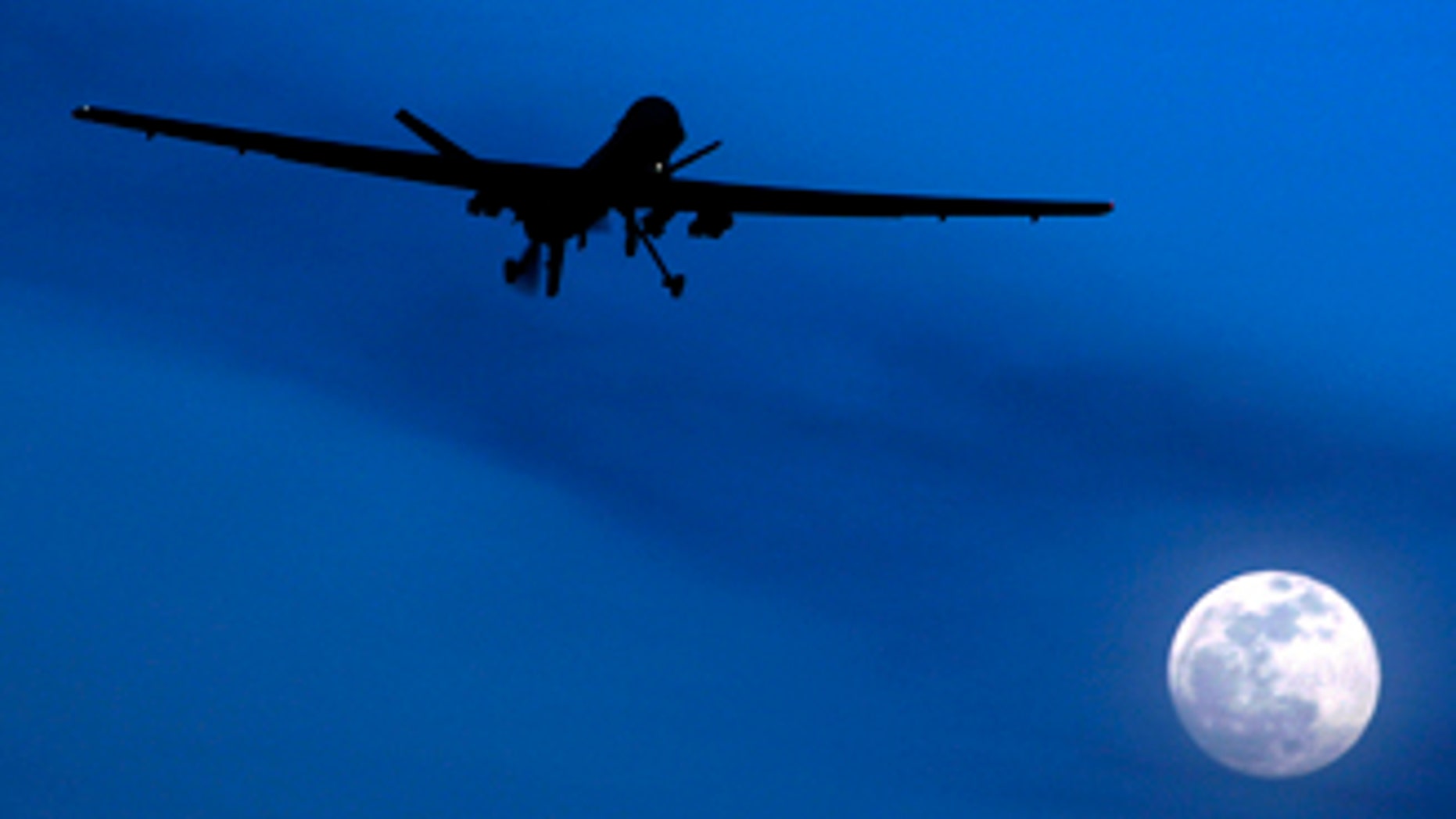 File: A predator drone flies over the moon above Kandahar Air Field in southern Afghanistan. U.S. missiles hit a suspected militant hide-out killing 16 insurgents in a troubled Pakistani tribal region along the Afghan border before dawn Saturday, July 24, intelligence officials said.