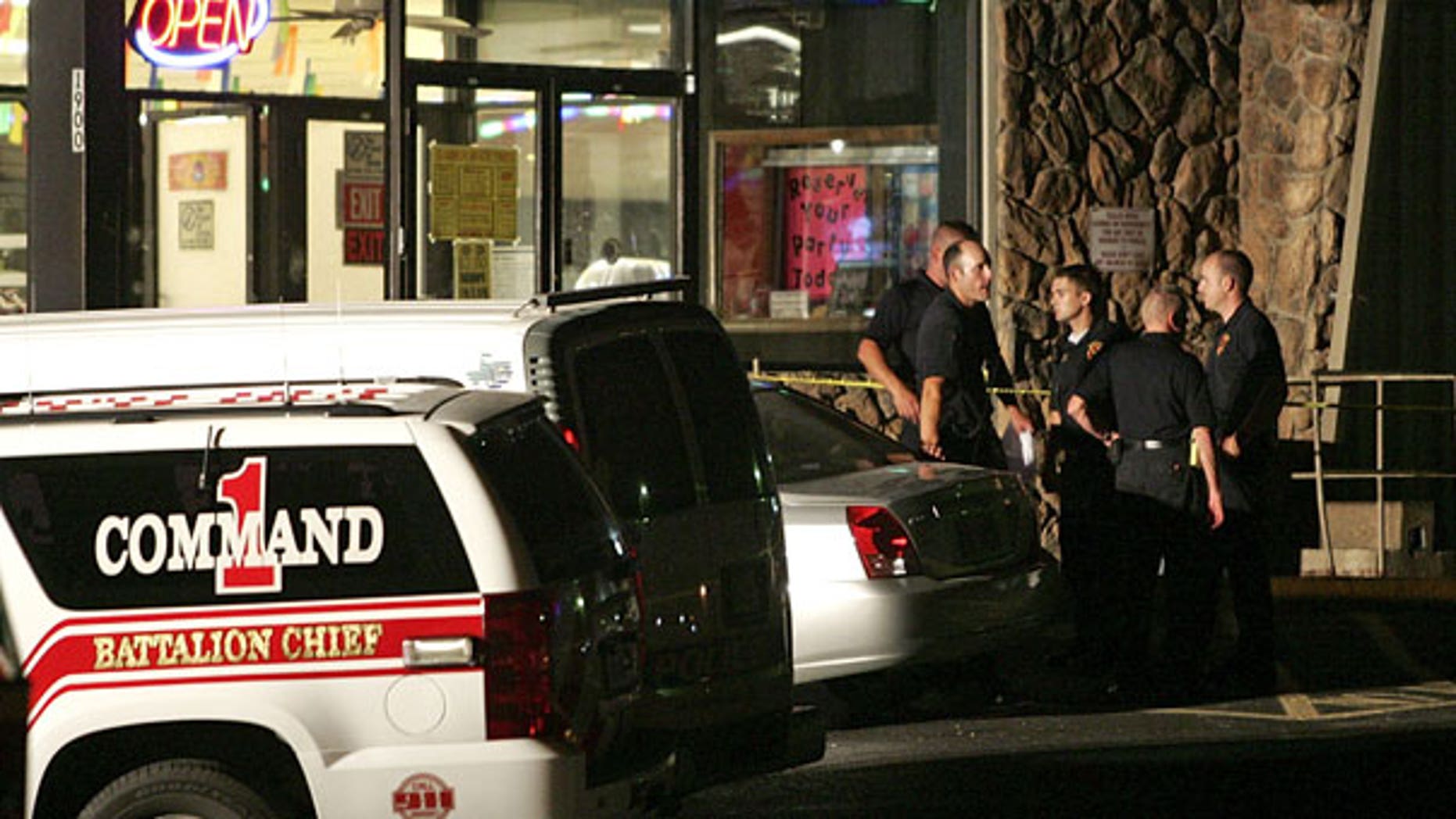 July 23: Emergency personnel wait outside the scene of a shooting at a roller rink in Grand Prairie, Texas A police chief says a gunman has died of a self-inflicted gunshot wound after killing five other people and injuring three at the roller rink.