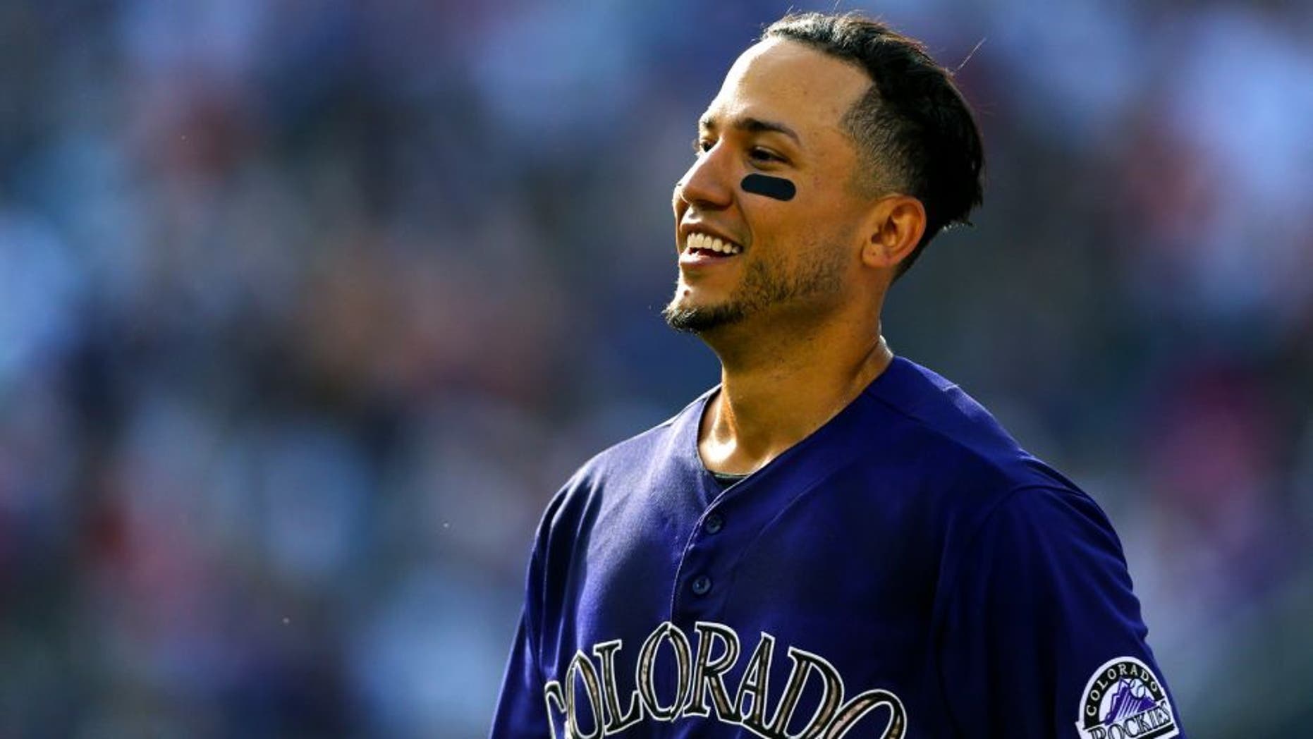 DENVER, CO - JULY 11: Carlos Gonzalez #5 of the Colorado Rockies smiles after he hit a walk-off RBI single against the Atlanta Braves in the ninth inning at Coors Field on July 11, 2015 in Denver, Colorado. The Rockies defeated the Braves 3-2. (Photo by Justin Edmonds/Getty Images)