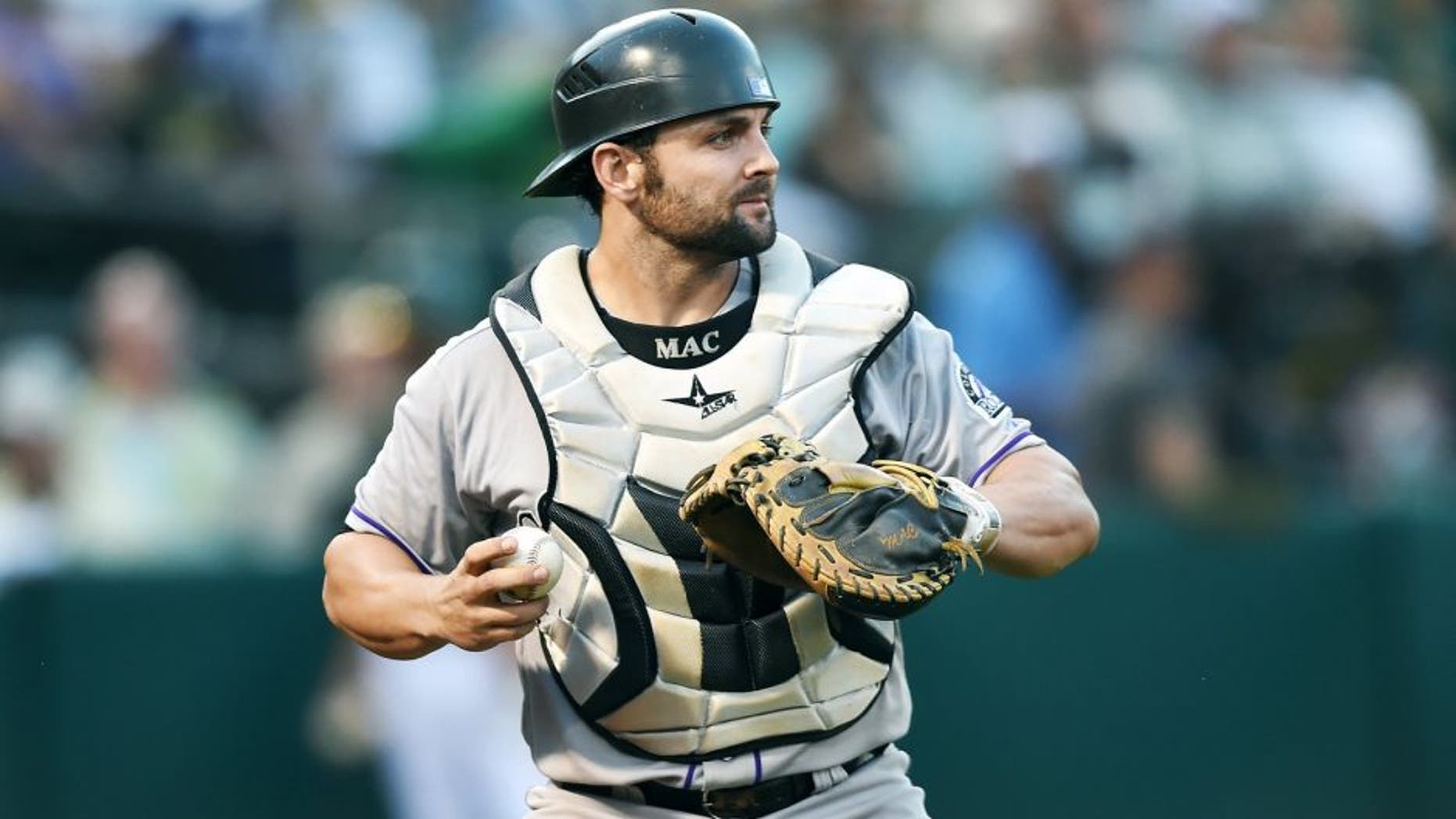 OAKLAND, CA - JUNE 30: Michael McKenry #8 of the Colorado Rockies turns to check the base runner after catching a foul pop-up off the bat of Billy Butler #16 of the Oakland Athletics in the bottom of the fourth inning at O.co Coliseum on June 30, 2015 in Oakland, California. (Photo by Thearon W. Henderson/Getty Images)