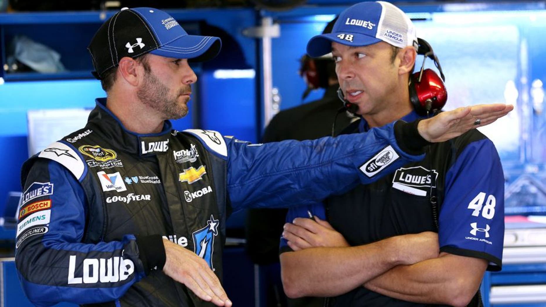 LONG POND, PA - JUNE 06: Jimmie Johnson, driver of the #48 Lowe's/Jimmie Johnson Foundation Chevrolet, left, talks with crew chief Chad Knaus in the garage area during practice for the NASCAR Sprint Cup Series Axalta 'We Paint Winners' 400 at Pocono Raceway on June 6, 2015 in Long Pond, Pennsylvania. (Photo by Nick Laham/Getty Images)