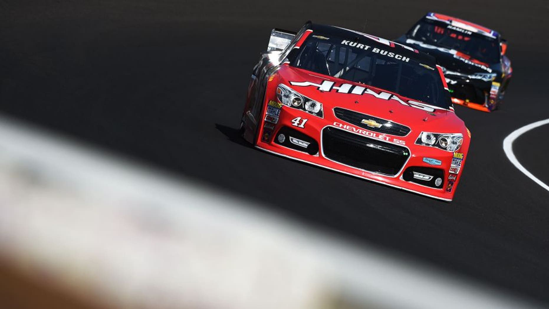 INDIANAPOLIS, IN - JULY 24: Kurt Busch, driver of the #41 Haas Automation Chevrolet, leads Denny Hamlin, driver of the #11 FedEx Express Toyota, during practice for the NASCAR Sprint Cup Series Crown Royal Presents the Jeff Kyle 400 at the Brickyard at Indianapolis Motorspeedway on July 24, 2015 in Indianapolis, Indiana. (Photo by Rainier Ehrhardt/NASCAR via Getty Images)