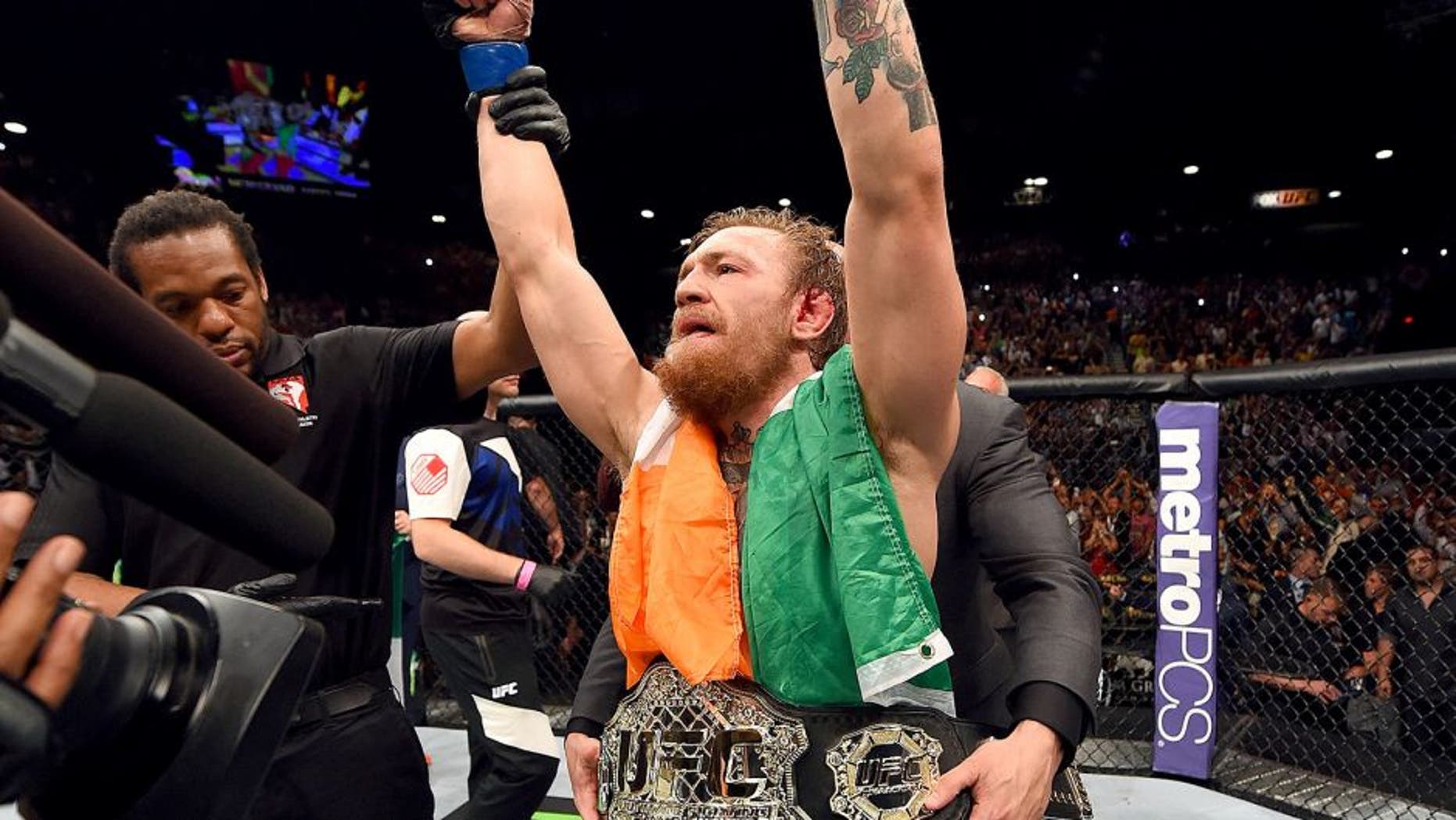 LAS VEGAS, NV - JULY 11: Conor McGregor reacts to his victory in their UFC interim featherweight title fight during the UFC 189 event inside MGM Grand Garden Arena on July 11, 2015 in Las Vegas, Nevada. (Photo by Josh Hedges/Zuffa LLC/Zuffa LLC via Getty Images)