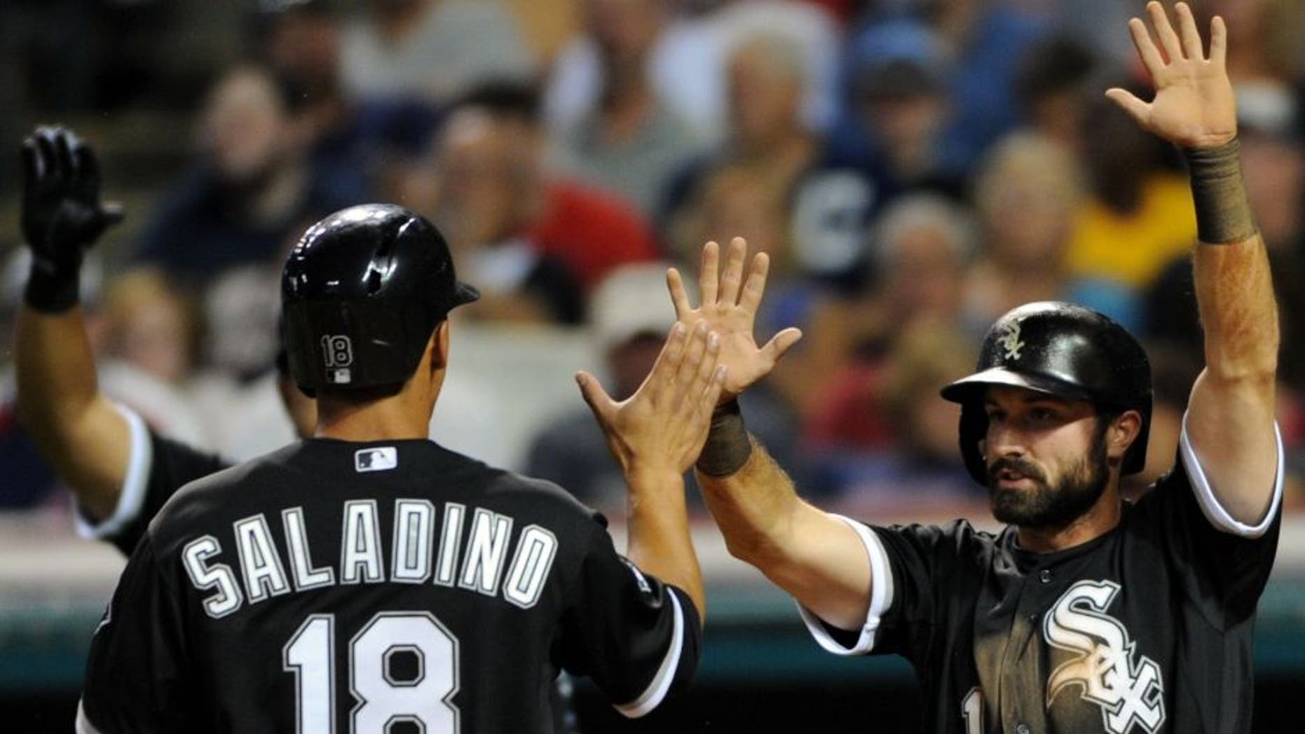 Jul 24, 2015; Cleveland, OH, USA; Chicago White Sox third baseman Tyler Saladino (18) and Chicago White Sox center fielder Adam Eaton (1) celebrate after scoring during the eighth inning against the Cleveland Indians at Progressive Field. Mandatory Credit