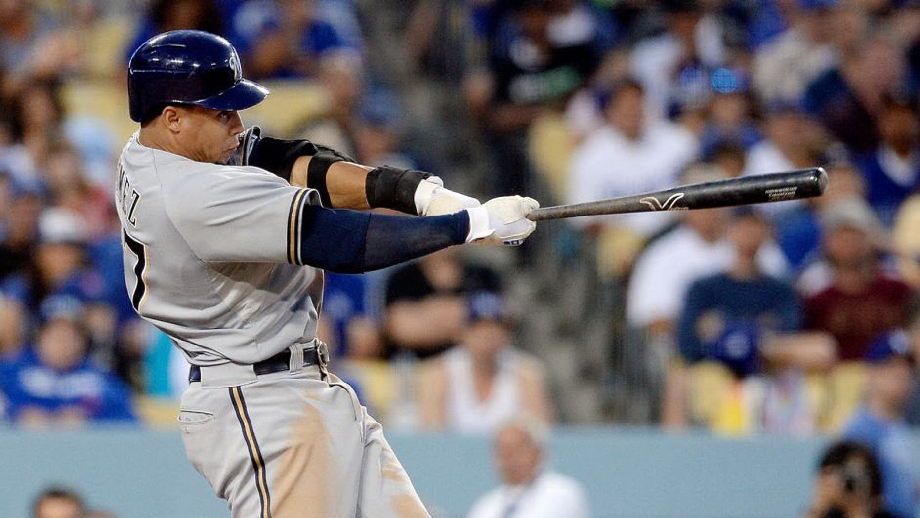 LOS ANGELES, CA - JULY 11: Carlos Gomez #27 of the Milwaukee Brewers hits a three run double during the third inning of the baseball game July 11, 2015 at Dodger Stadium in Los Angeles, California. (Photo by Kevork Djansezian/Getty Images)