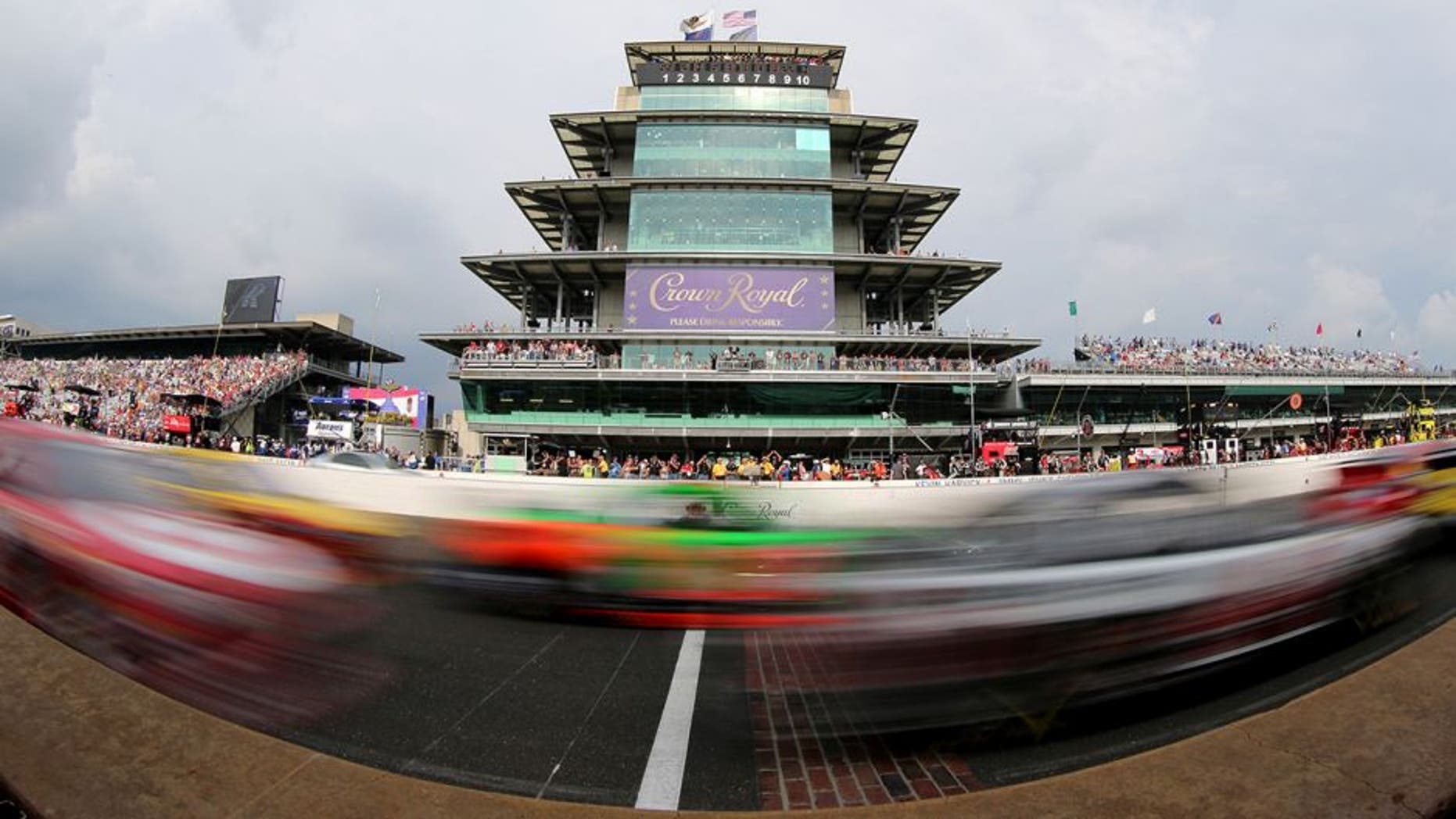 INDIANAPOLIS, IN - JULY 26: Cars race by during the NASCAR Sprint Cup Series Crown Royal Presents the Jeff Kyle 400 at the Brickyard at Indianapolis Motor Speedway on July 26, 2015 in Indianapolis, Indiana. (Photo by Brian Lawdermilk/Getty Images)