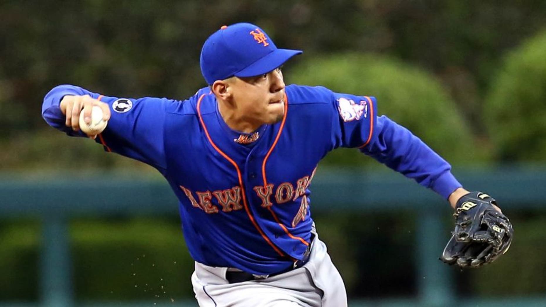 May 29, 2014; Philadelphia, PA, USA; New York Mets shortstop Wilmer Flores (4) attempts to throw out a runner in the second inning of a game against the Philadelphia Phillies at Citizens Bank Park. Mandatory Credit: Bill Streicher-USA TODAY Sports